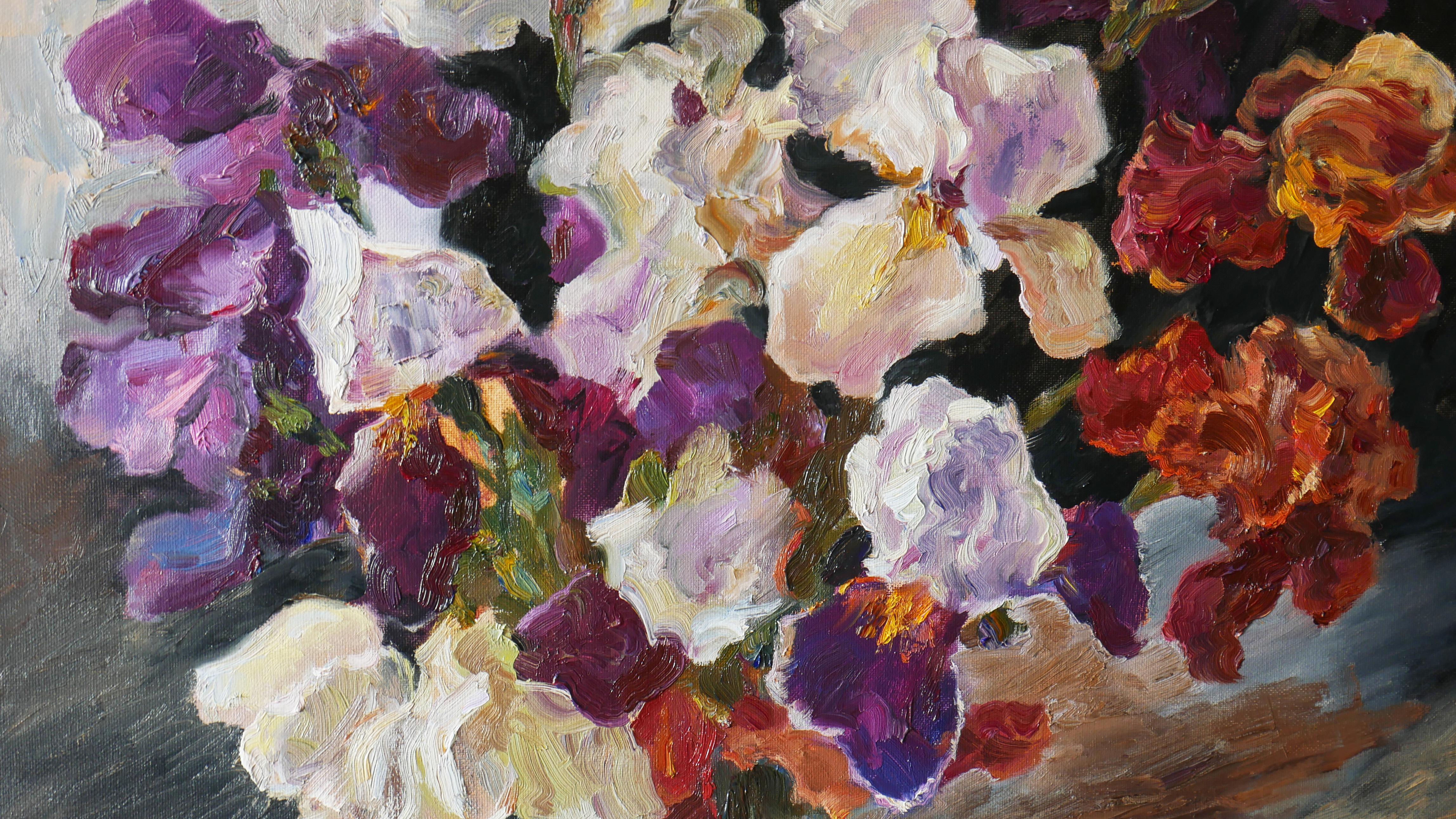 A lush bouquet of irises bursts forth from a transparent blue vase. Stems intertwine in an elegant dance. Each bloom is a masterpiece of nature. Deep purples, blues, and buttery yellows blend seamlessly, velvety petals catching the light. Shadows
