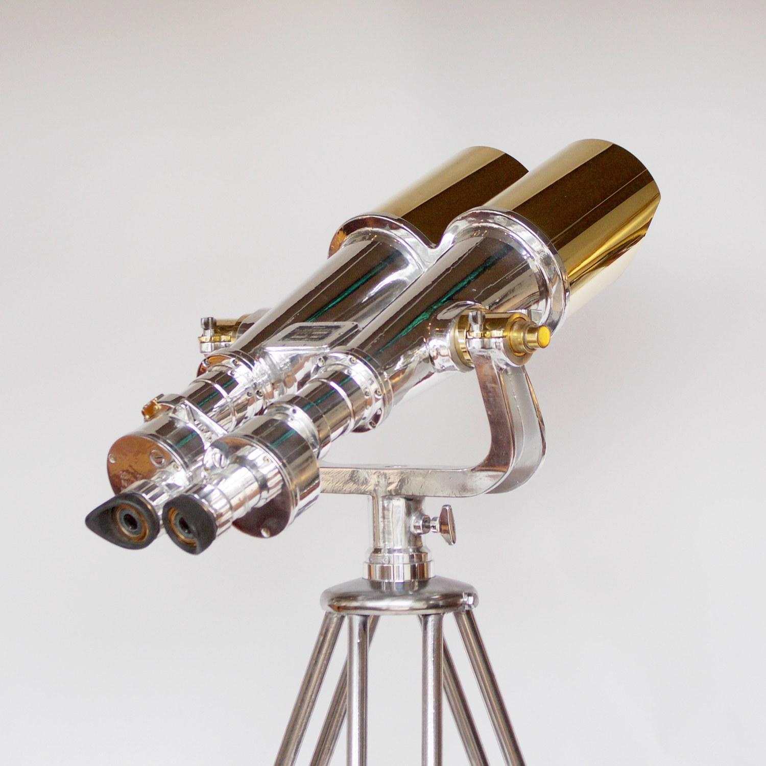 A pair of chromed metal and brass Nikon 20 x 120 WW11 Naval Binoculars. Set on an original 1940s military, re-polished metal stand.

20x magnification with 120mm objective lenses. Paint stripped and metal polished. Optics fully