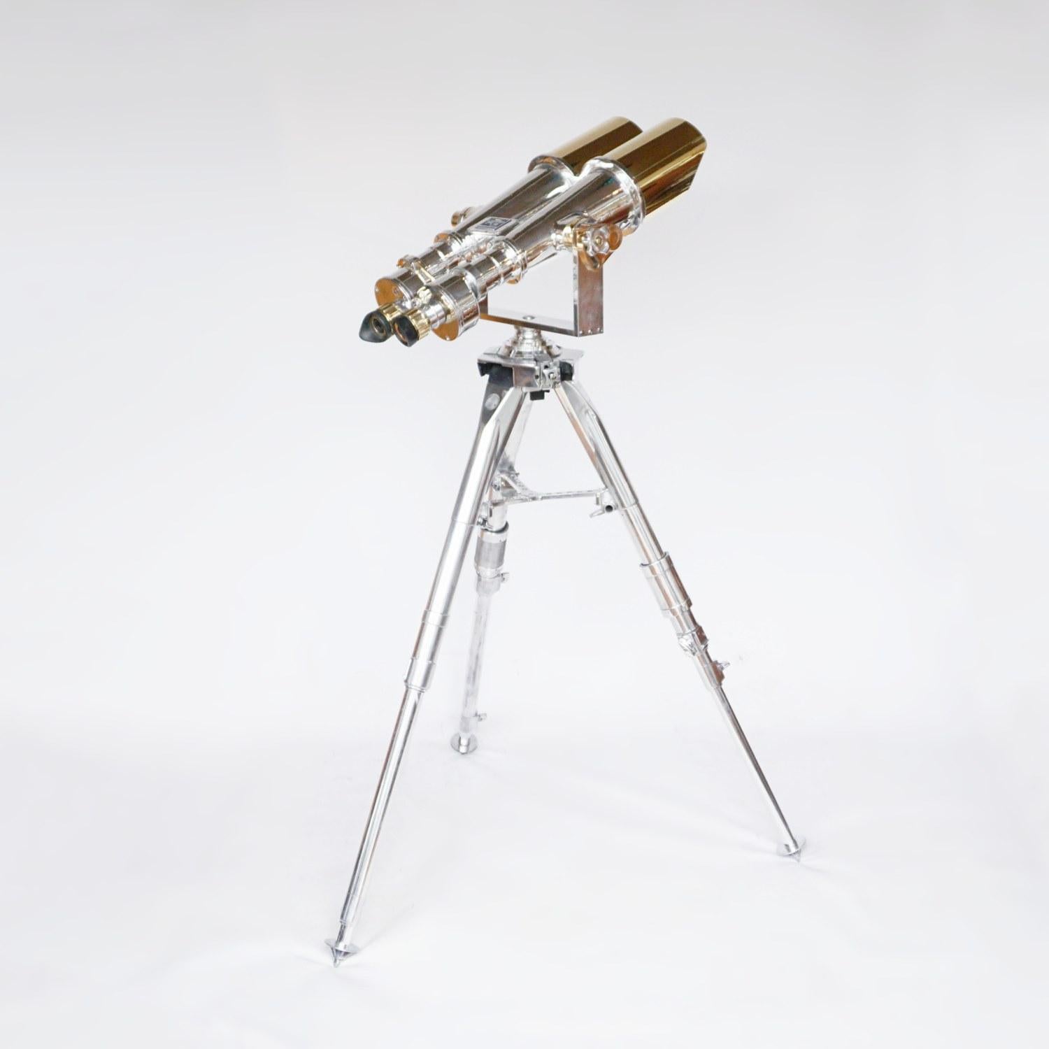 Chromed metal and brass Nikon 20x120 WW11 Naval Binoculars. Set on an original Zeiss 1960's military, re-polished metal stand.

20x magnification with 120mm objective lenses. Paint stripped and metal polished. Optics fully