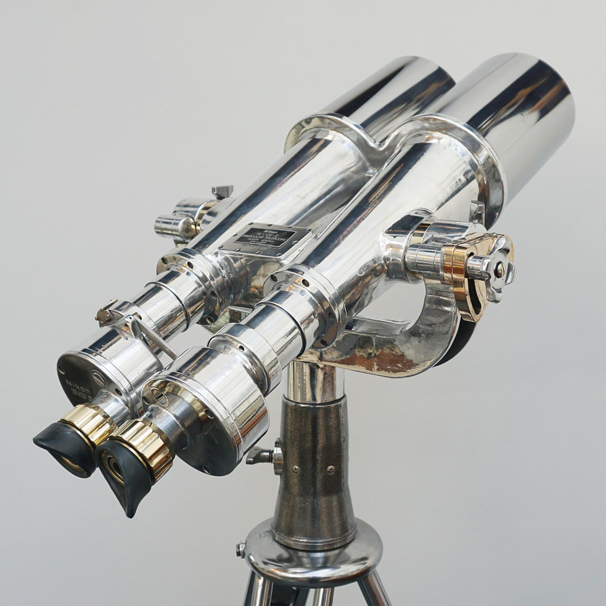 Chromed metal and brass Nikon 20x120 WW11 naval binoculars. Set on a later 1960'\s re-polished metal stand.

20x Magnification with 120mm objective lenses. Paint stripped and metal polished. Optics fully refurbished.

Dimensions: H 15cm W 47cm L