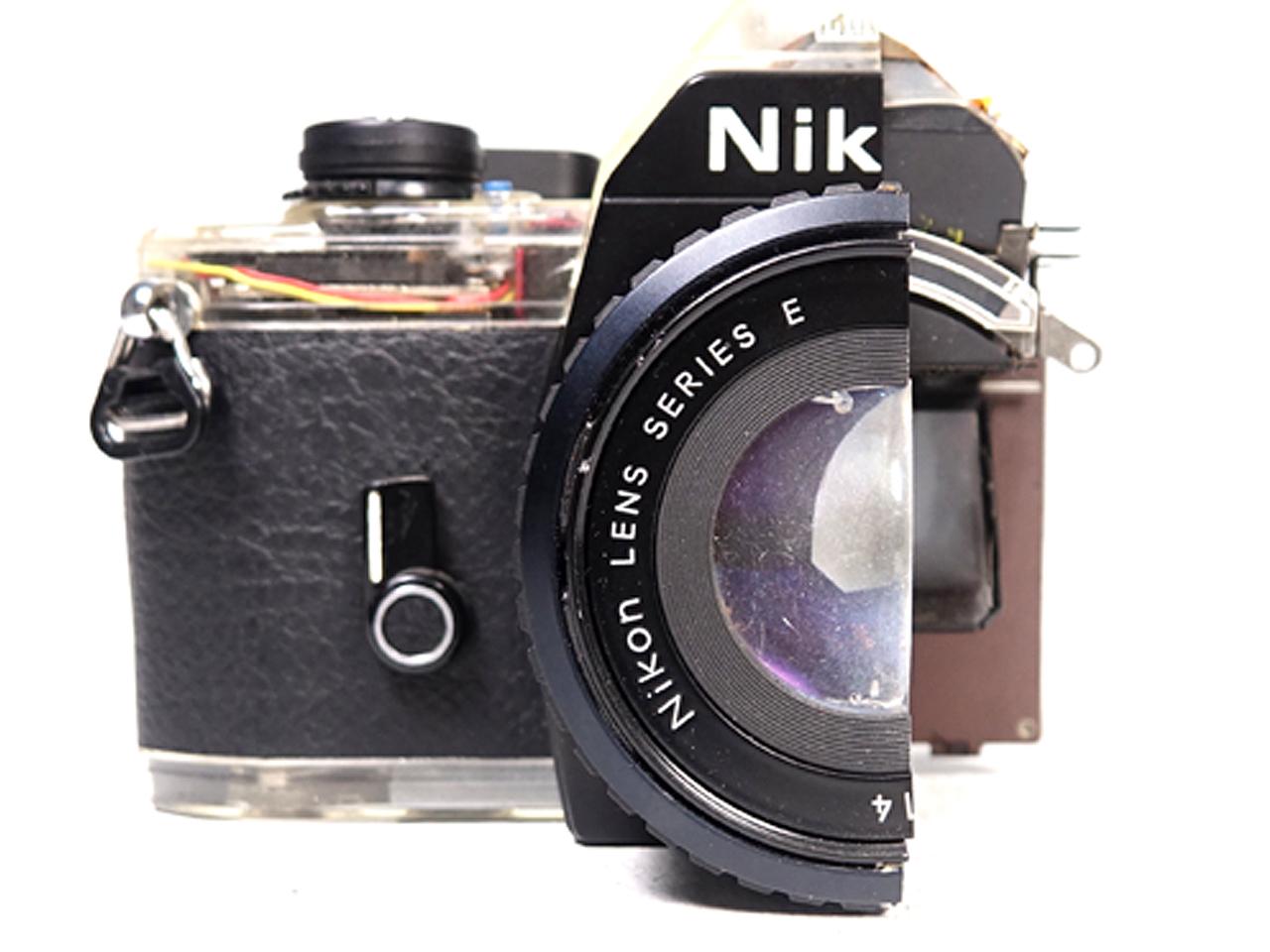 This was a full size precision cut-away of a real Nikon EM. Everything was cut down the middle to show how complex the camera was. They cut everything including the lenses. In addition the bottom and the top of the camera body was also cast in a