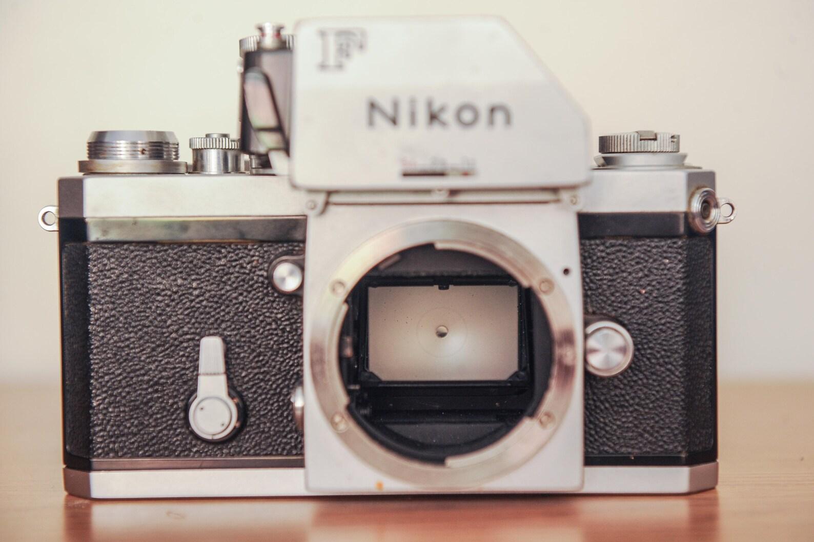 Machine Age Nikon's Photomic FTn 35mm SLR Camera Fitted with Nikkor-H 50mm Prime Lens F2.0  For Sale