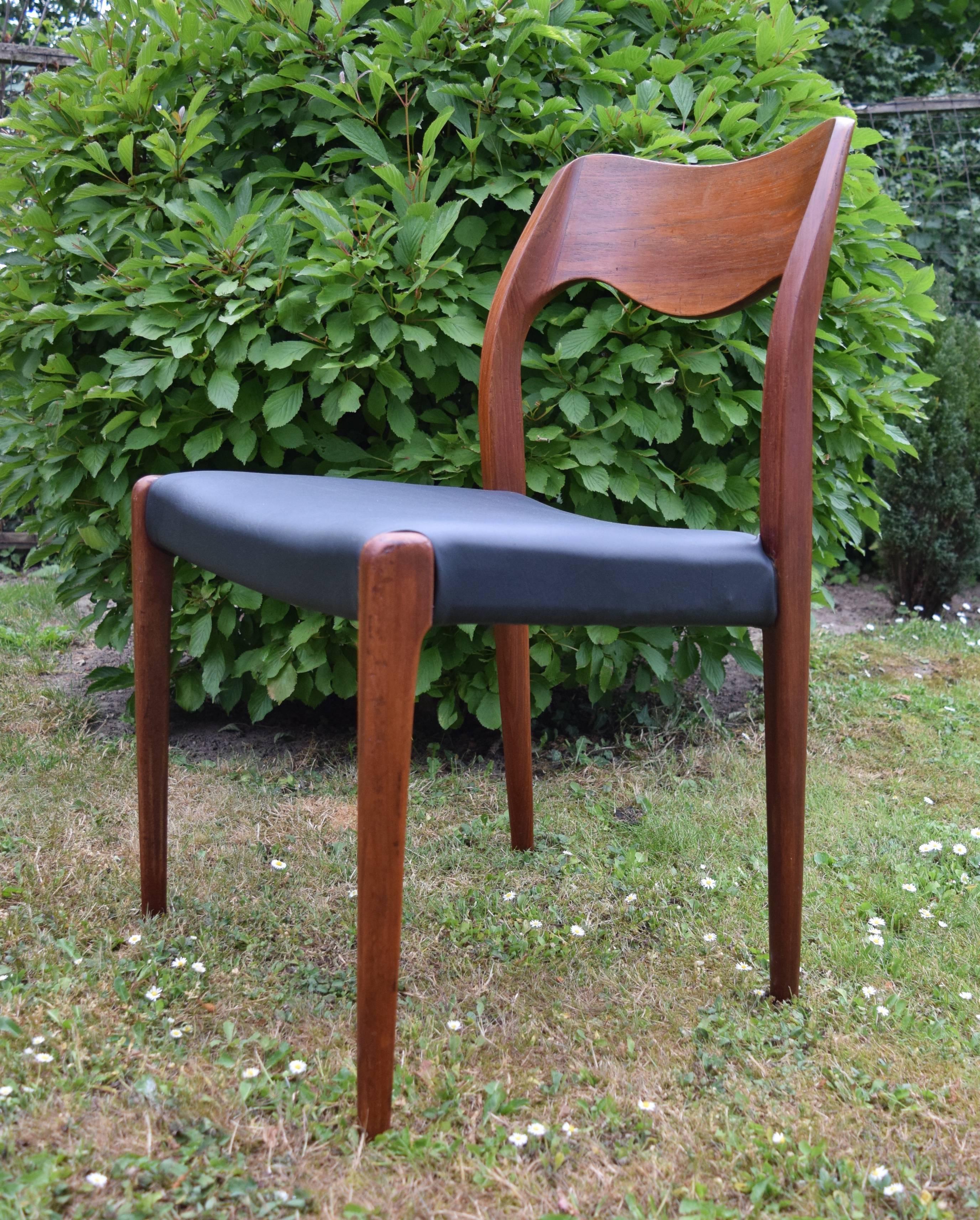 Teak dining chair model 71 designed by Niels Møller in Denmark in 1951. This particular example has been recently covered in high quality black vinyl. Apart from some marks on the frame this chair is in a good condition.