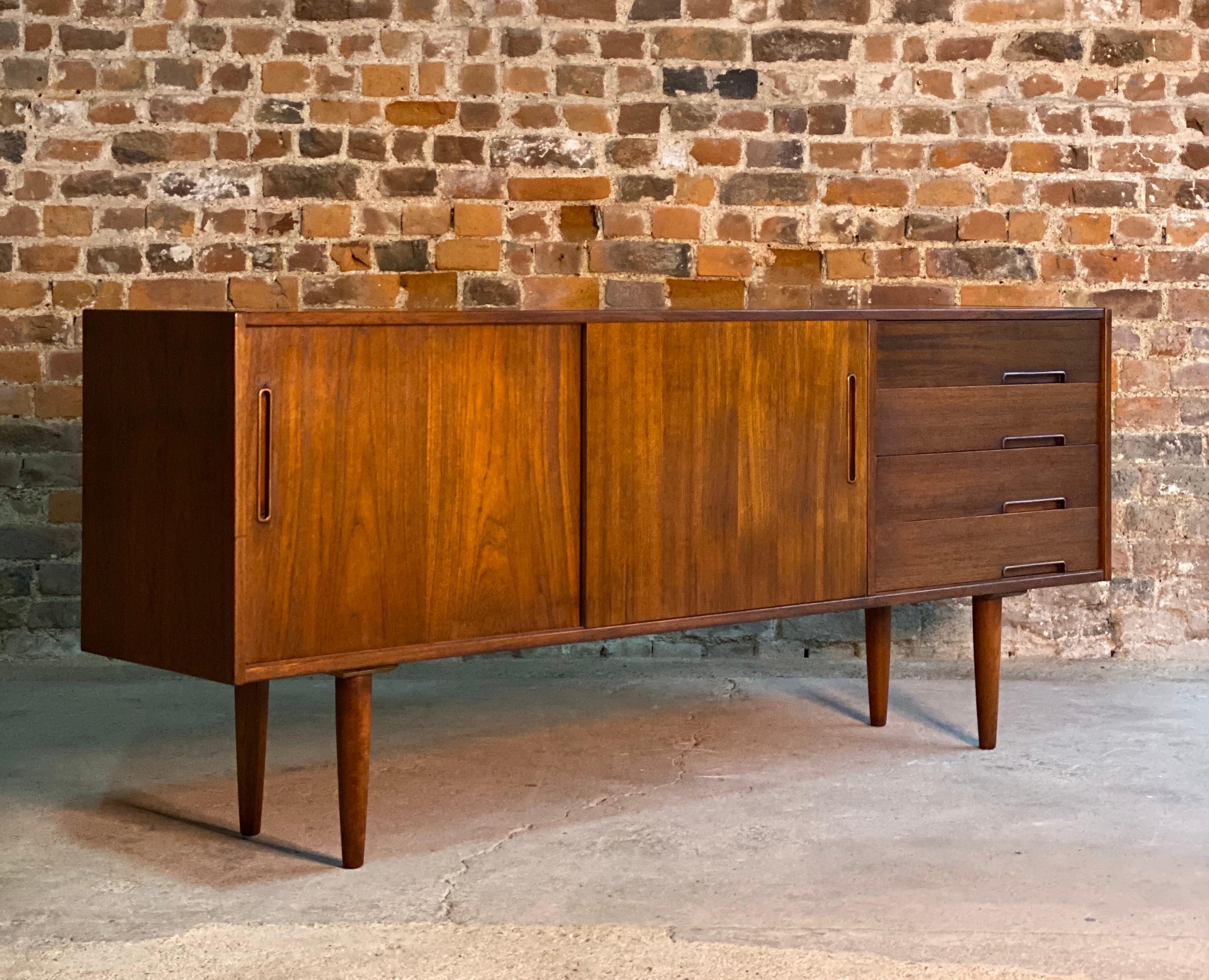 Nils Johnsson Trento teak sideboard for Troeds Bjärnum, Sweden, circa 1970

Nils Johnsson for Troeds Bjärnum, Sweden, circa 1970, a teak sideboard model trento, circa 1970s, fitted with two sliding doors and four drawers to the right side and