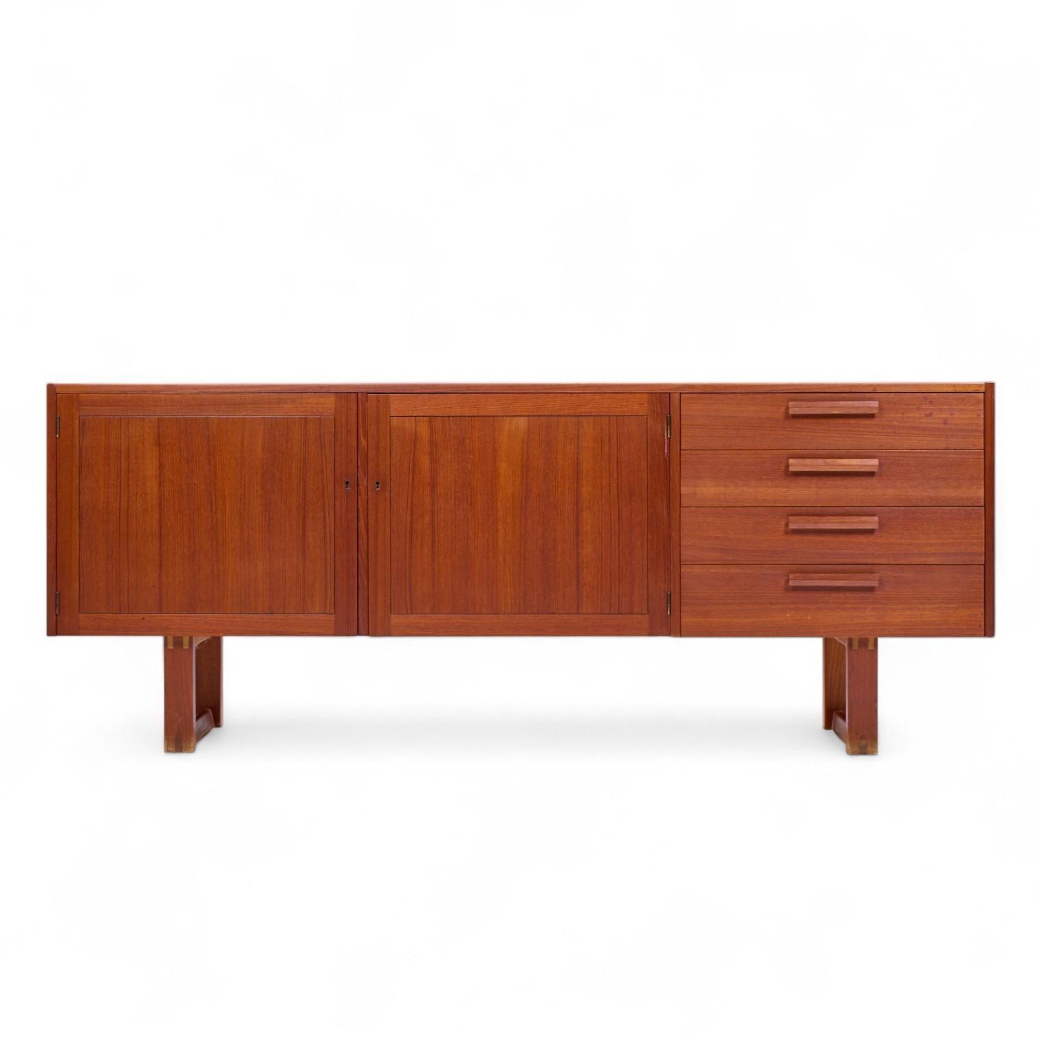 Nils Jonsson for Troeds Domi Monté Mid Century Swedish Teak Credenza

This credenza measures: 74.75 wide x 17 deep x 29.5 inches high

Great Vintage Condition - Minor Areas of Stain Wear on Top Surface. Wear at the Bottom of the Feet. Doors and