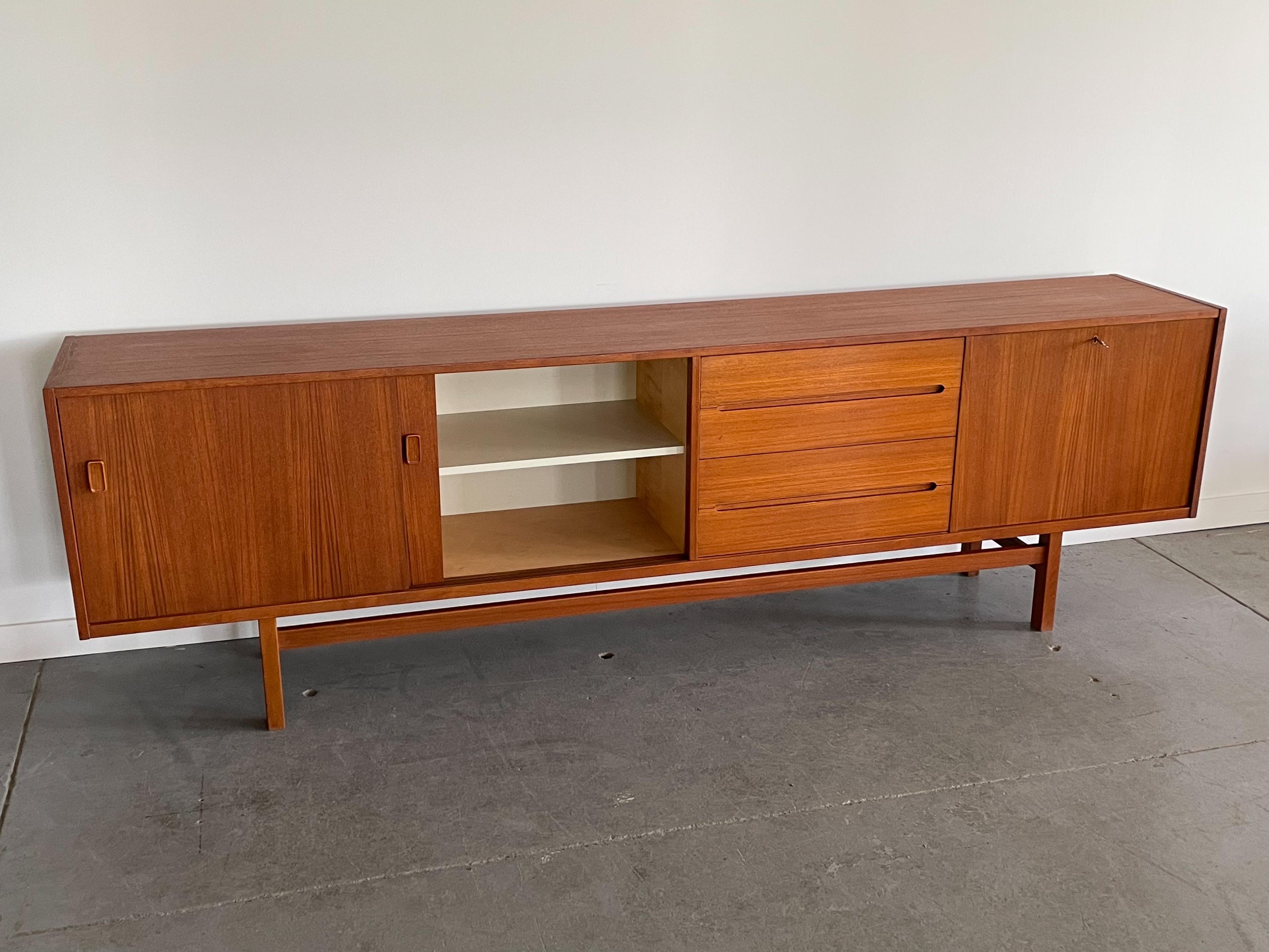 One of the largest storage pieces out there. This monumental teak ’Grand’ credenza by Nils Jonsson for Hugo Troeds, Sweden, offers a variety of ample storage options including shelves, drawers, and a drop-down bar cabinet. It features nicely