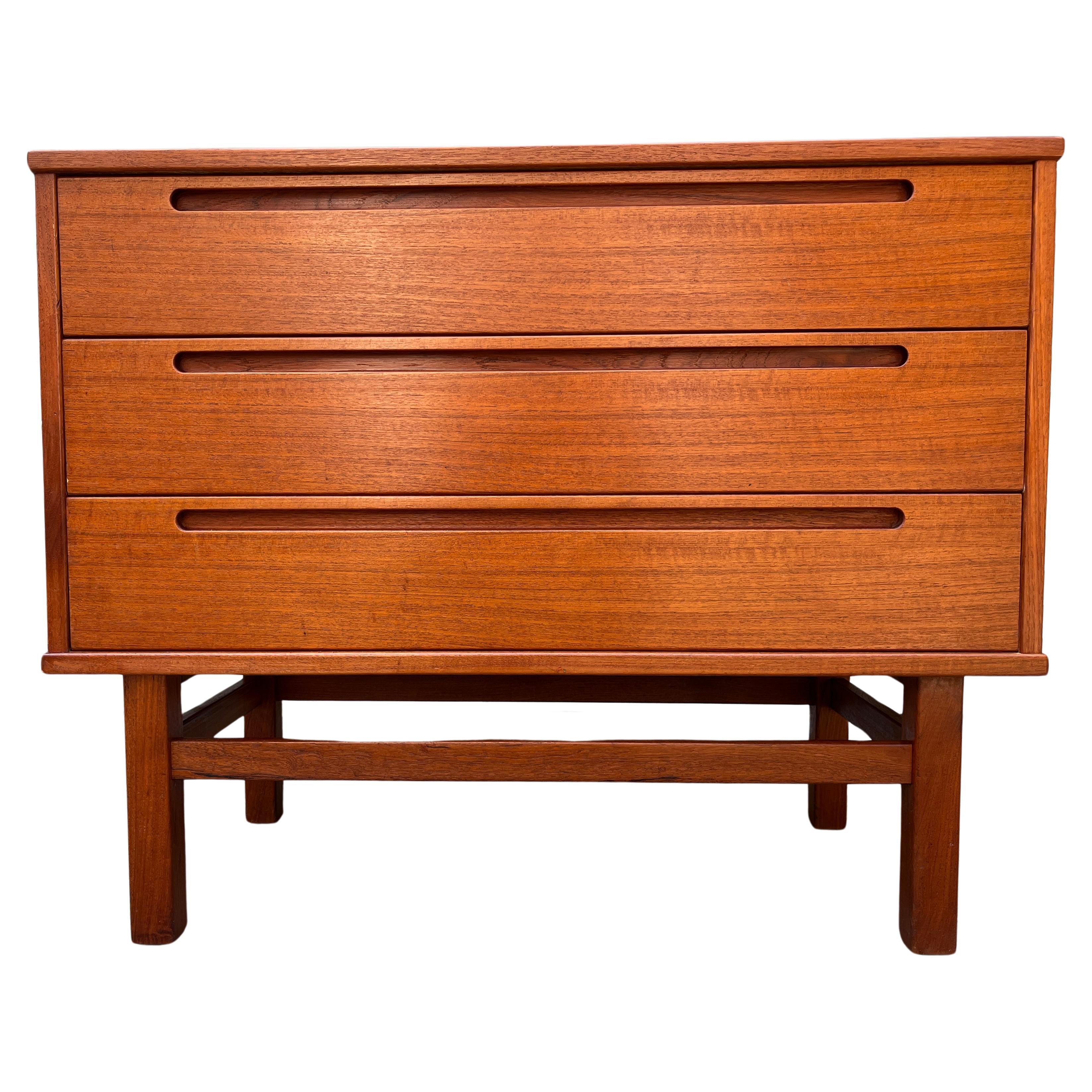 Danish Mid-Century Modern chest of drawers in excellent unrestored condition. Perfect vintage example of simple modernism. Nils Jonsson three-drawer dresser in oiled Teak. Clean inside and out.