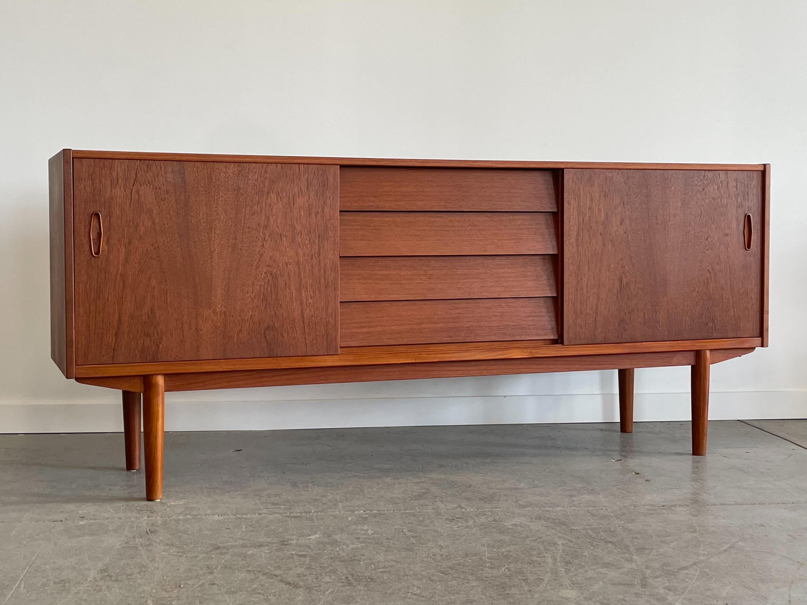 Teak ‘Trio’ credenza designed by Nils Jonsson for Troeds, Sweden. This piece features a combination drawer and adjustable shelf storage. The drawers are constructed from solid maple with box joinery and there is a felt-lined cutlery tray. The drawer