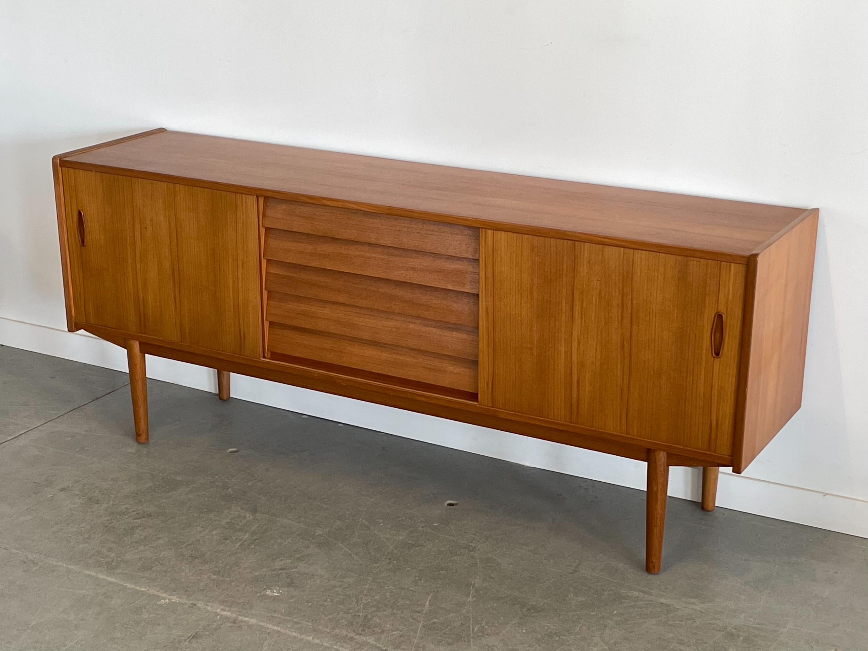 Teak ‘Trio’ credenza designed by Nils Jonsson for Troeds, Sweden. This piece features a combination drawer and adjustable shelf storage. The drawers are constructed from solid maple with box joinery and there is a felt-lined cutlery tray. The drawer