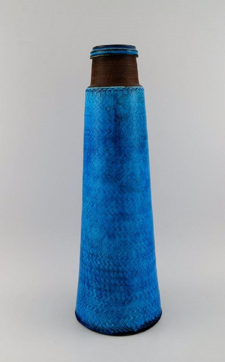 Nils Kähler (1906-1979) for Kähler. 
Colossal vase in glazed stoneware. Beautiful glaze in shades of blue. 
1960s.
Measures: 53 x 18 cm.
In excellent condition.
Signed.