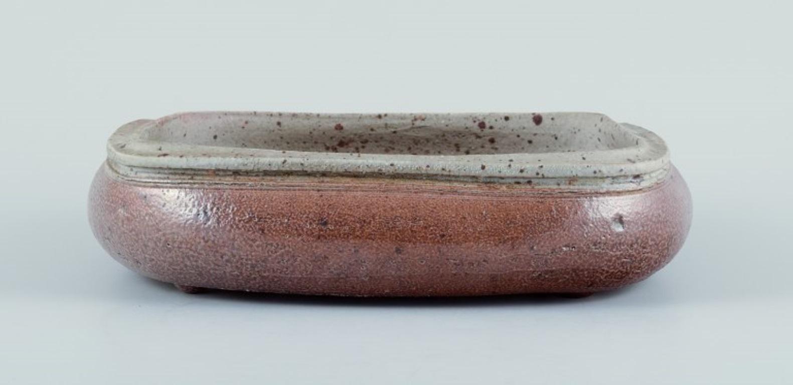 Danish Nils Kähler for Kähler, ceramic bowl on four low feet. Square shape. For Sale