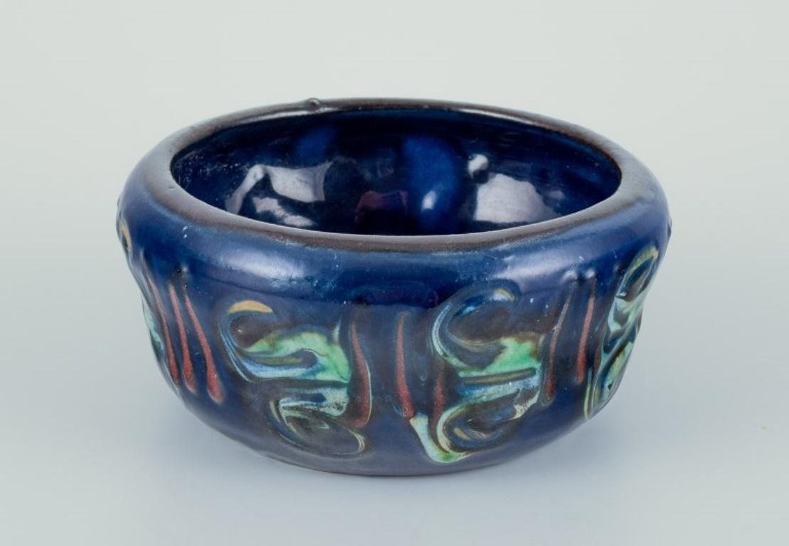 Nils Kähler for Kähler. 
Small ceramic bowl and small vase with turquoise glaze.
Approximately 1970.
Marked.
In perfect condition with natural cracks in the glaze.
Bowl: Diameter 11.5 cm x Height 2.5 cm.
Vase: Height 5.7 cm x Diameter 6.5 cm.