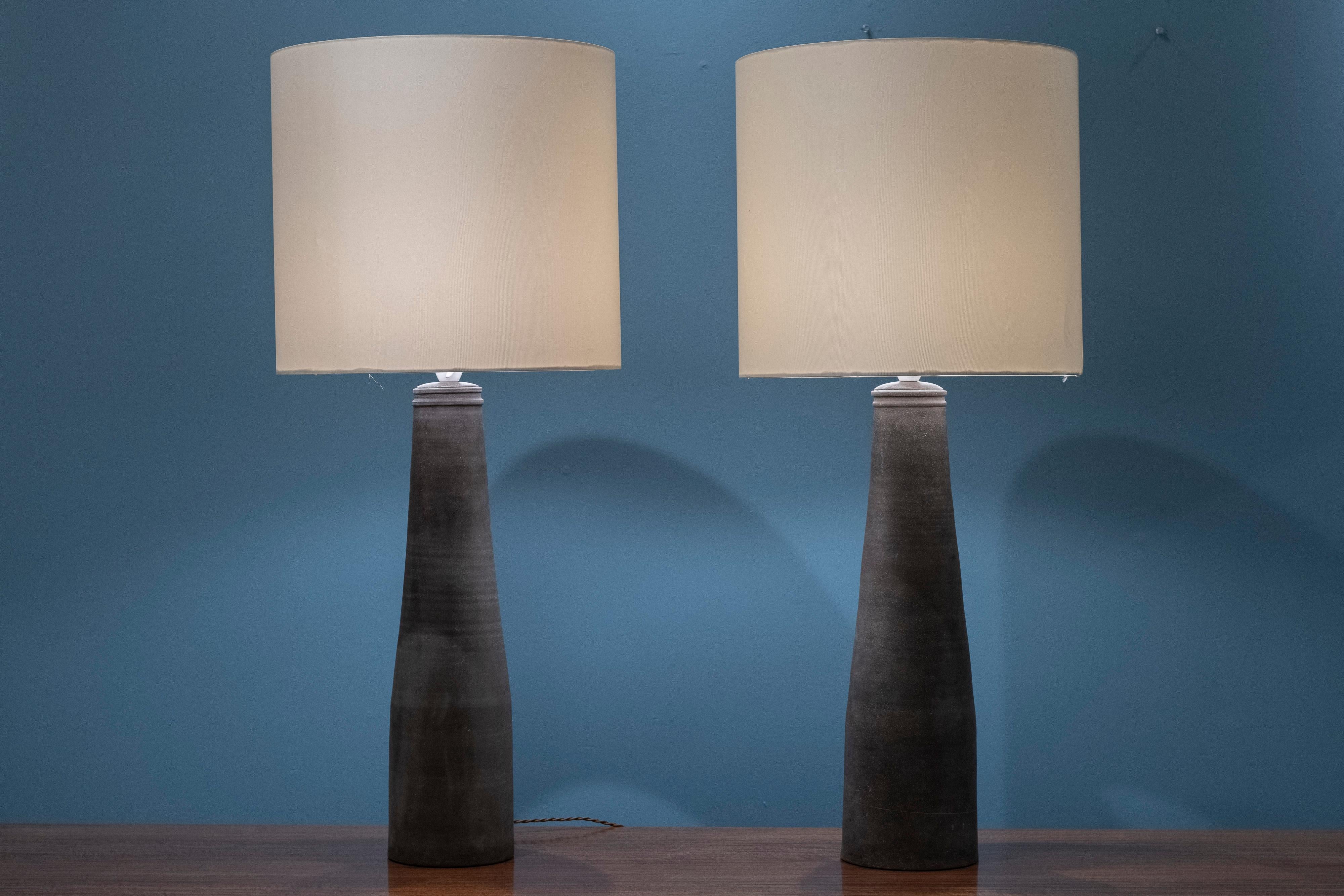 Nils Kahler design ceramic table lamps for Herman A Kahler, Denmark. Impressive and large scale pair of lamps, organic and imperfect form that is stunning. Rare model in very good original condition with new wiring and good but not perfect shades.