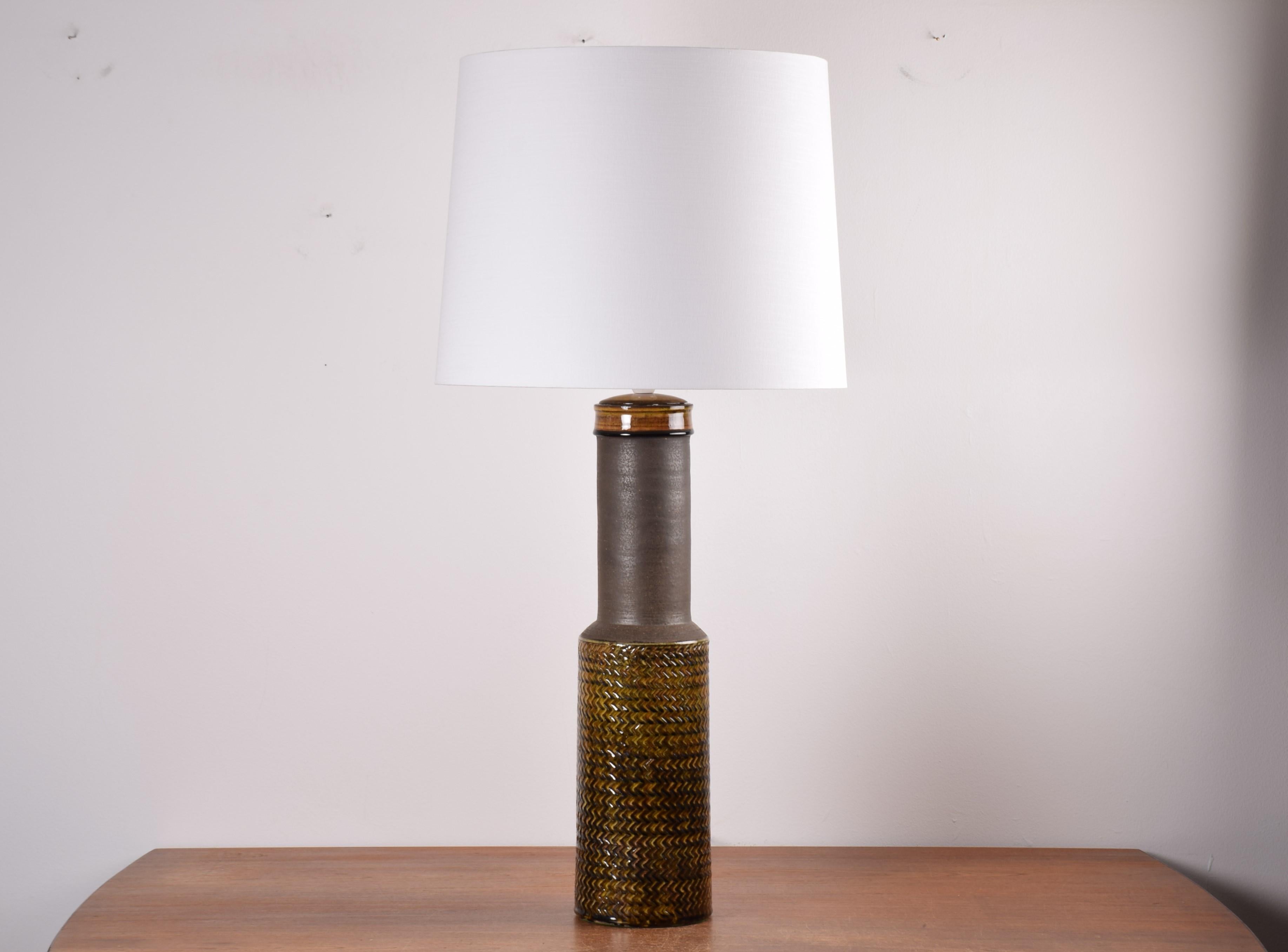 Huge table lamp - or floor lamp if you like - by Nils Kähler for Danish ceramic studio Kähler (HAK). Made circa 1960s.
The lamp shade is included.

The lamp has an unglazed long neck which is very smooth. The top and body have yellow / amber