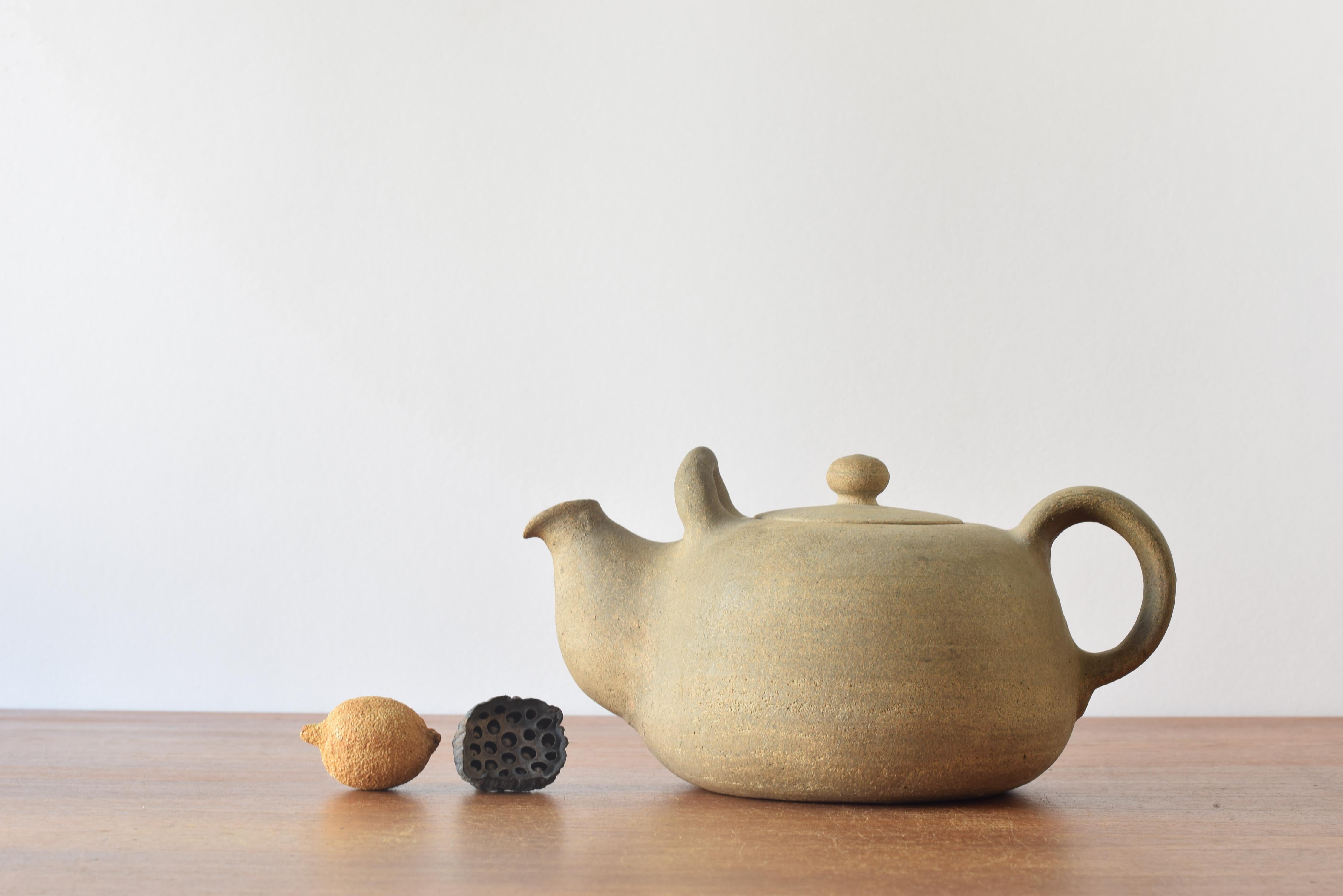 Decorative vintage Danish huge teapot by Nils Kähler for the ceramic workshop Herman August Kähler (HAK). Made ca. 1950s. This is a rare piece.

The budded shape with soft curves plays well with the material clay which here shows itself in