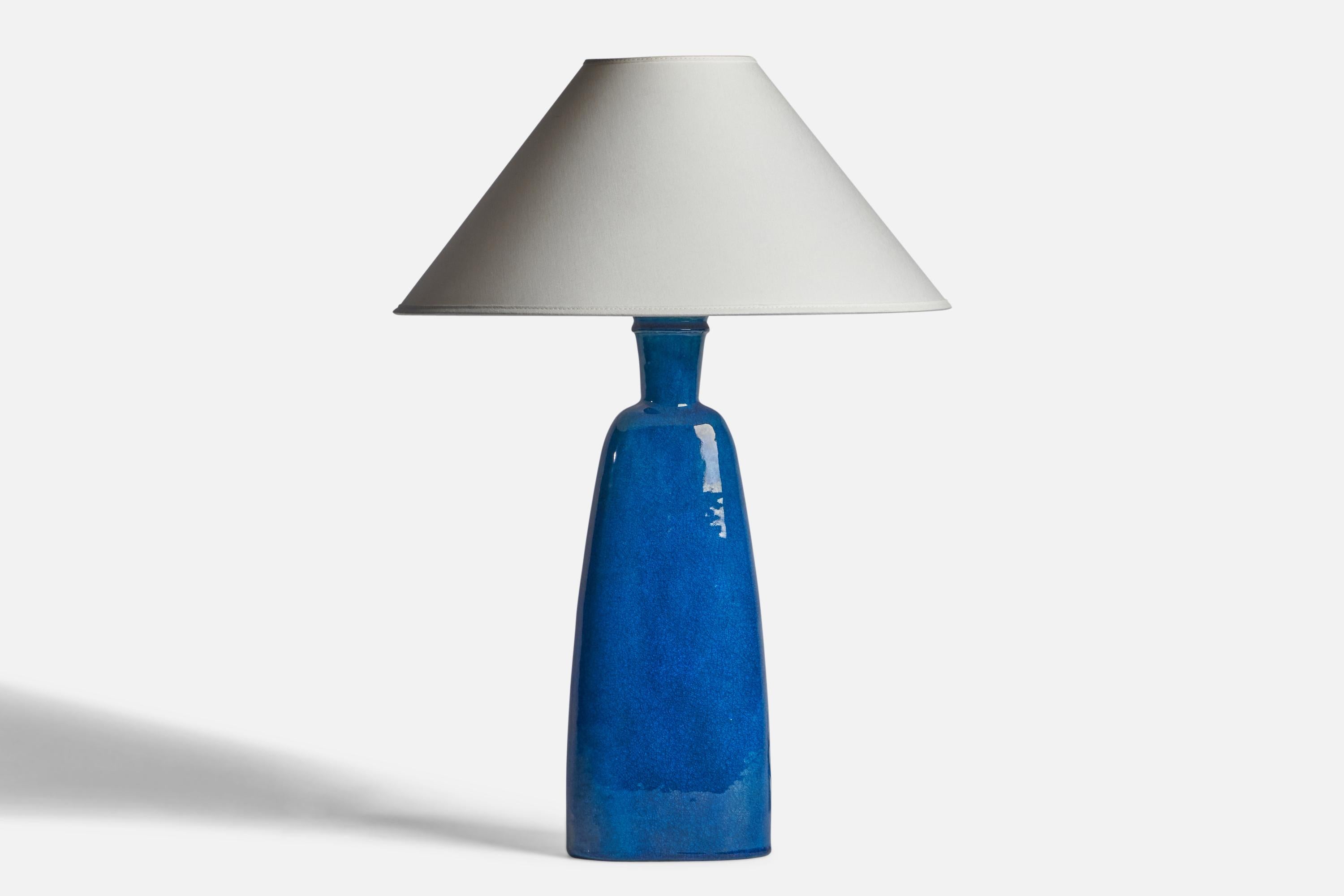 A sizeable blue-glazed ceramic table lamp designed and produced by Nils Kähler, Denmark, c. 1950s.

Dimensions of Lamp (inches): 18.25” H x 6” Diameter
Dimensions of Shade (inches): 4.5” Top Diameter x 16” Bottom Diameter x 7.25” H
Dimensions of