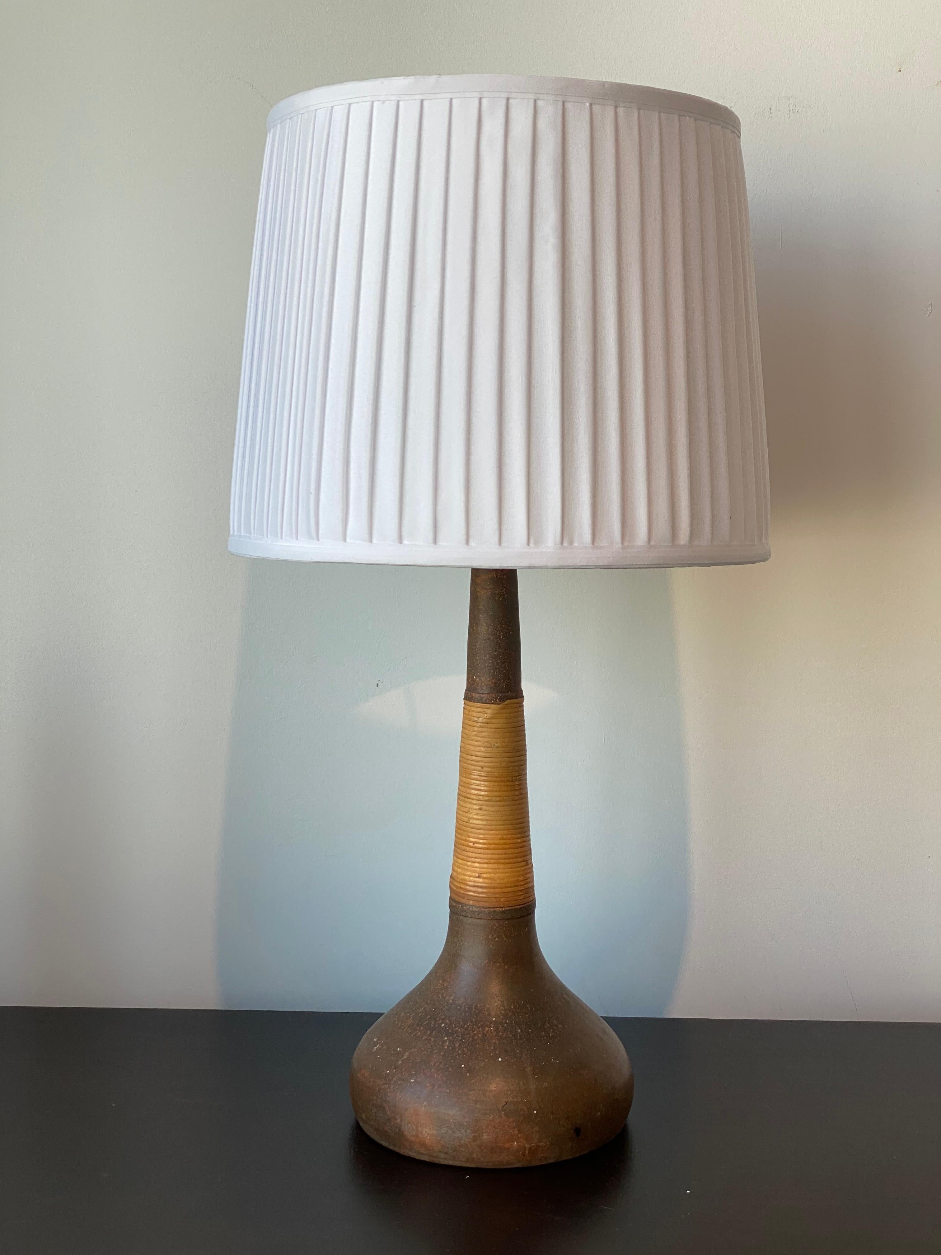 A table lamp designed by Nils Kähler. Produced for Le Klint, Denmark, 1950s. In glazed stoneware and wrapped cane. 

Purchase does not include lampshade. Please see second image for lamps current configuration.

Other designers of the period