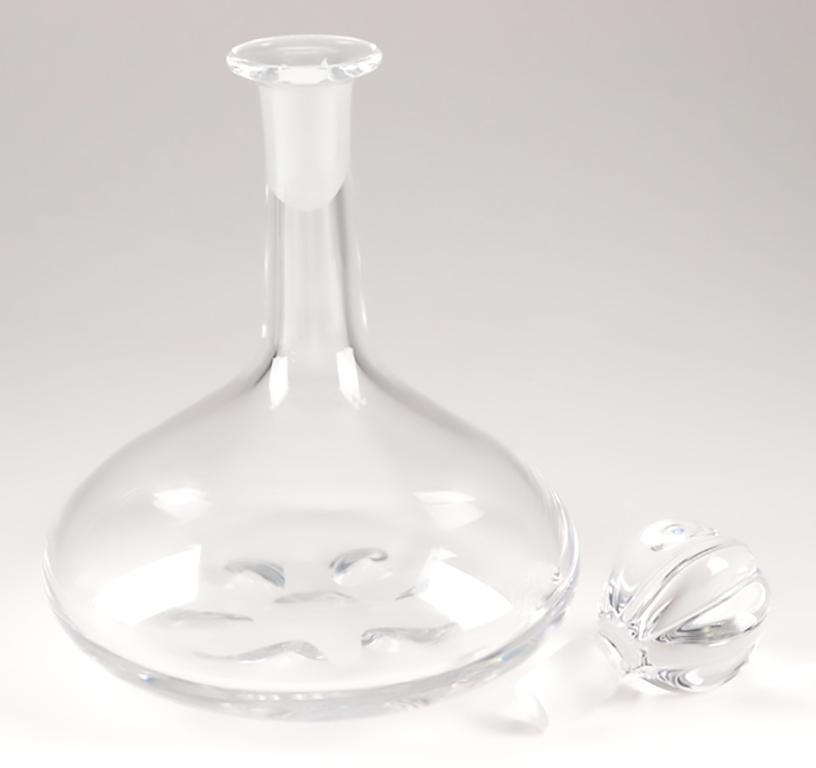 Heavy crystal ship decanter by Nils Landberg for Orrefors, number 4200-731. The shape of the decanter, with the weight being spread out at the base, is designed to not tip over on a ship when the waves jostle the ship. Signed.