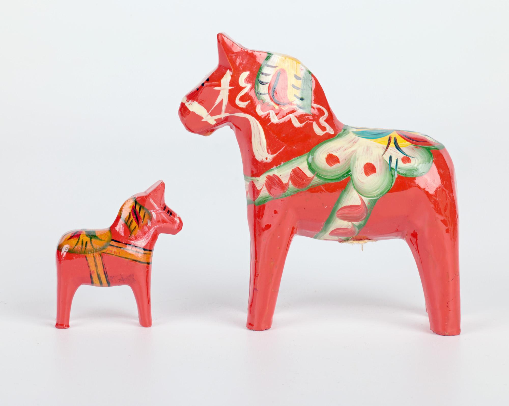 A very stylish and typically Scandinavian Swedish mid-century hand painted graduated set of carved wooden horse figures by Nils Olsson and dating from around 1950. The figures are each similarly carved standing from a very miniature example to a
