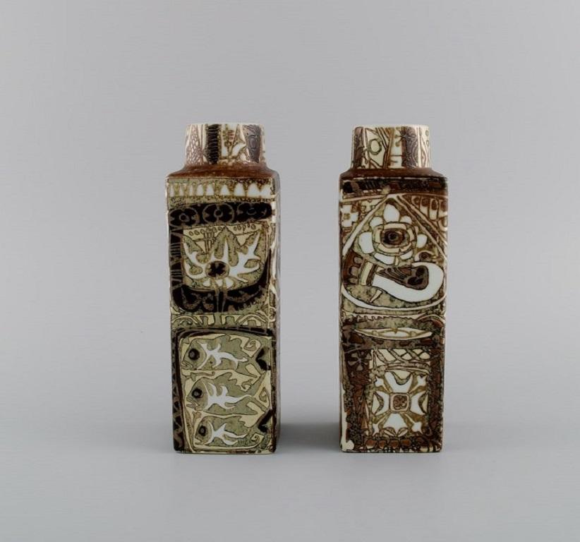 Nils Thorsson and Johanne Gerber for Aluminia, Royal Copenhagen. 
Two Baca vases decorated with birds and fish, patterned glaze in sand and light brown shades. 1970s.
Measures: 19 x 6 cm.
In excellent condition.
Stamped.
1st factory quality.