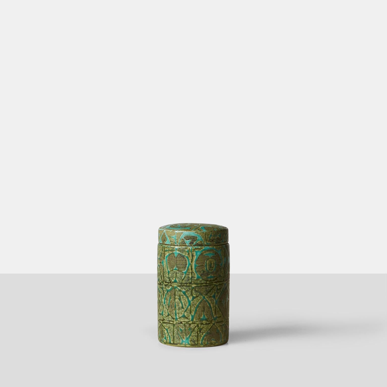 A glazed stoneware jar with a geometric, abstract design in relief. Designed by Nils Thorsson for Royal Copenhagen. Marked accordingly.