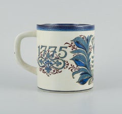 Nils Thorsson for Royal Copenhagen, Anniversary mug in earthenware, 1775-1975