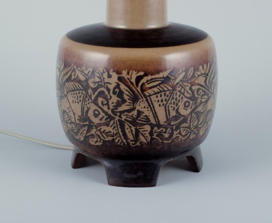 Danish Nils Thorsson for Royal Copenhagen. Table lamp in stoneware with a motif of fish For Sale