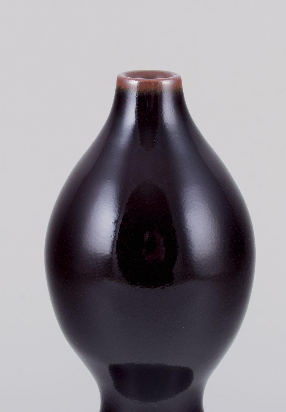 Pre-owned goods are exempt from import duties for U.S. customers. 
Therefore, no import tariffs will be applicable to your purchase.

Nils Thorsson for Royal Copenhagen.
Unique stoneware vase, double gourd-shaped.
Aubergine