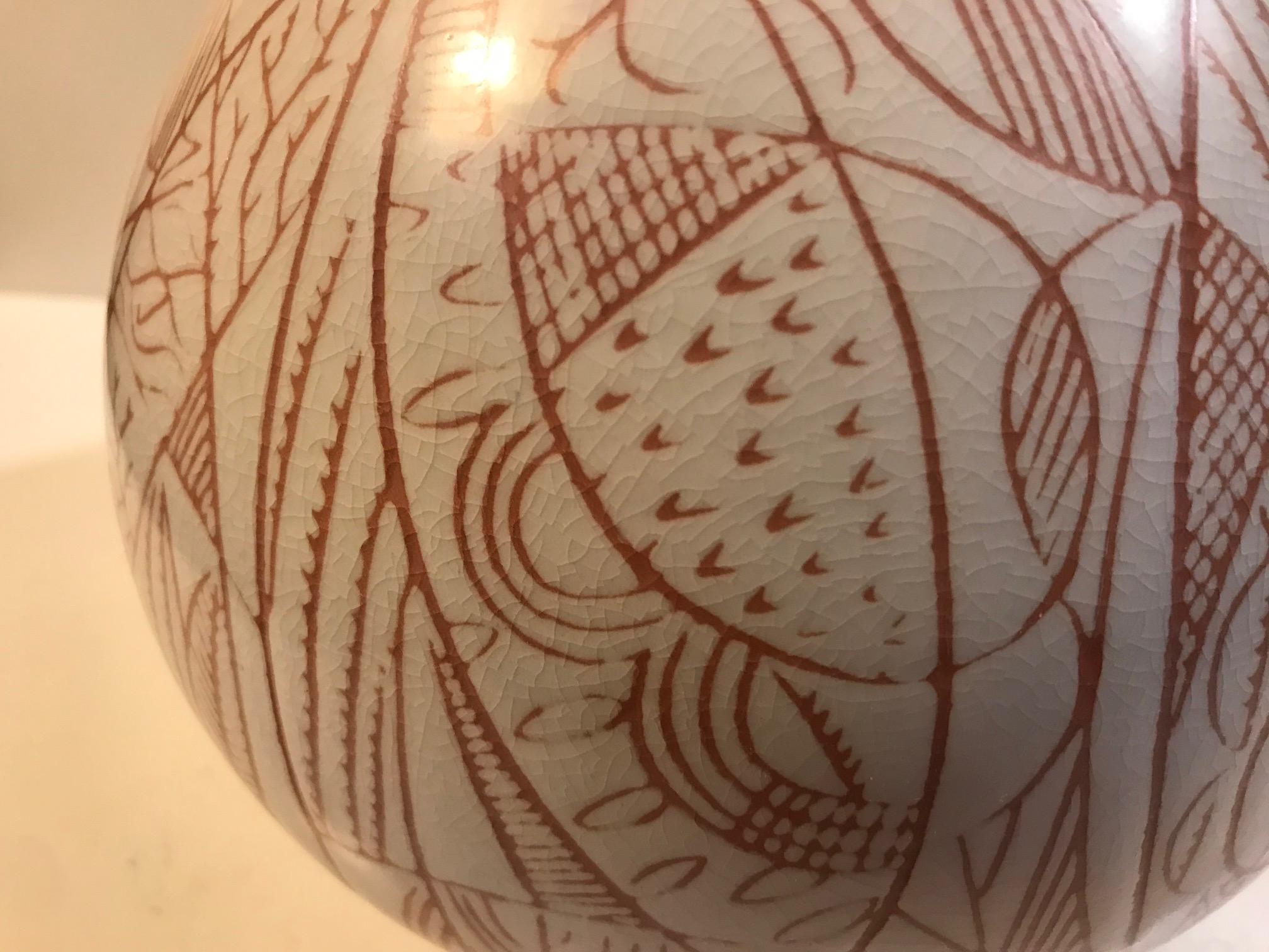 Extremely rare faience vase designed by Nils Thorsson. Closely related to his Løvspring series but still very different. It features a pure ovoid shape, abstract nature inspired decor and intended crazing to the white glaze. Its a rather large piece