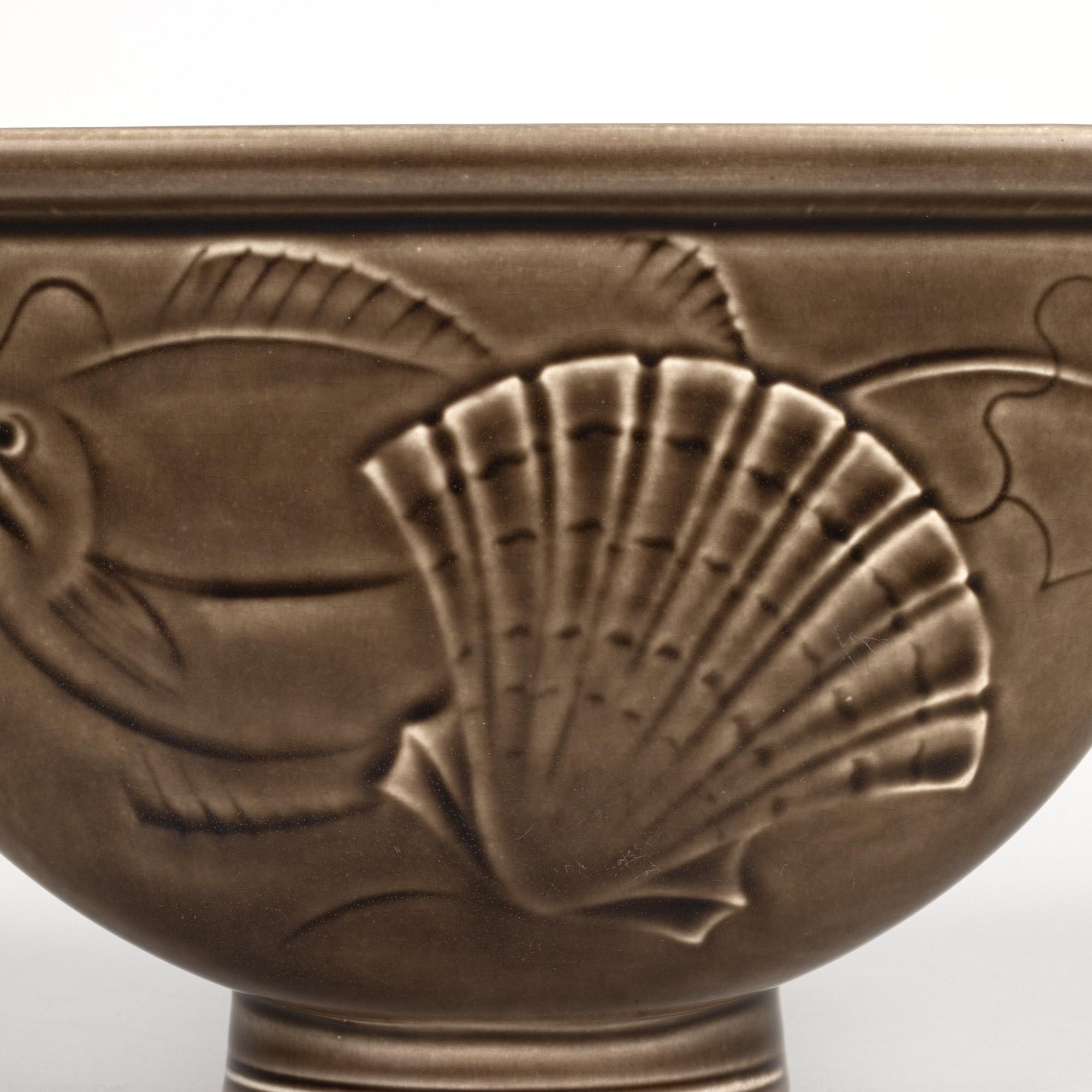 A stunning Danish mid-century Royal Copenhagen Aluminia Fajence art pottery vase from the Solberg series designed by renowned ceramicist Nils Thorsson (Swedish, 1898-1975) in the 1930’s dating from 1953. The unusual shaped ceramic vase stands raised