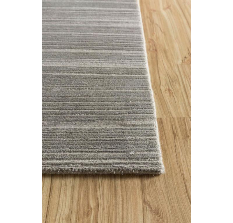 Emanating a sense of refined luxury, perfect for transforming any space into a haven of comfort and style, this rug from our Manifest collection reflects all that. The soft gray and nickel hues of this rug create a harmonious palette, evoking a