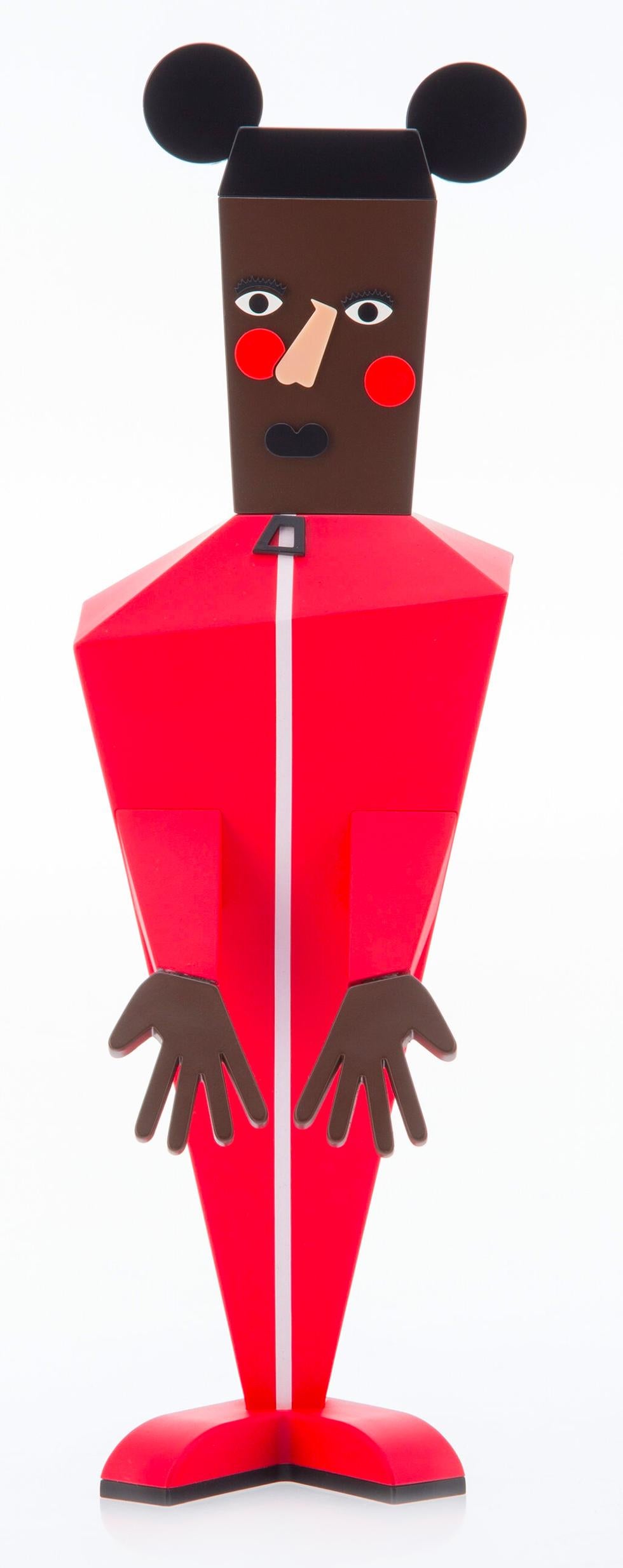 Nina Chanel Abney Baby: 
Nina Chanel’s 'Baby' figure strikingly re-imagines Mickey Mouse as a man dressed in a bright red jumpsuit, with mirroring red circles stamped on the cheeks. Constructed with sharp angles and an asymmetrical mold, the figure
