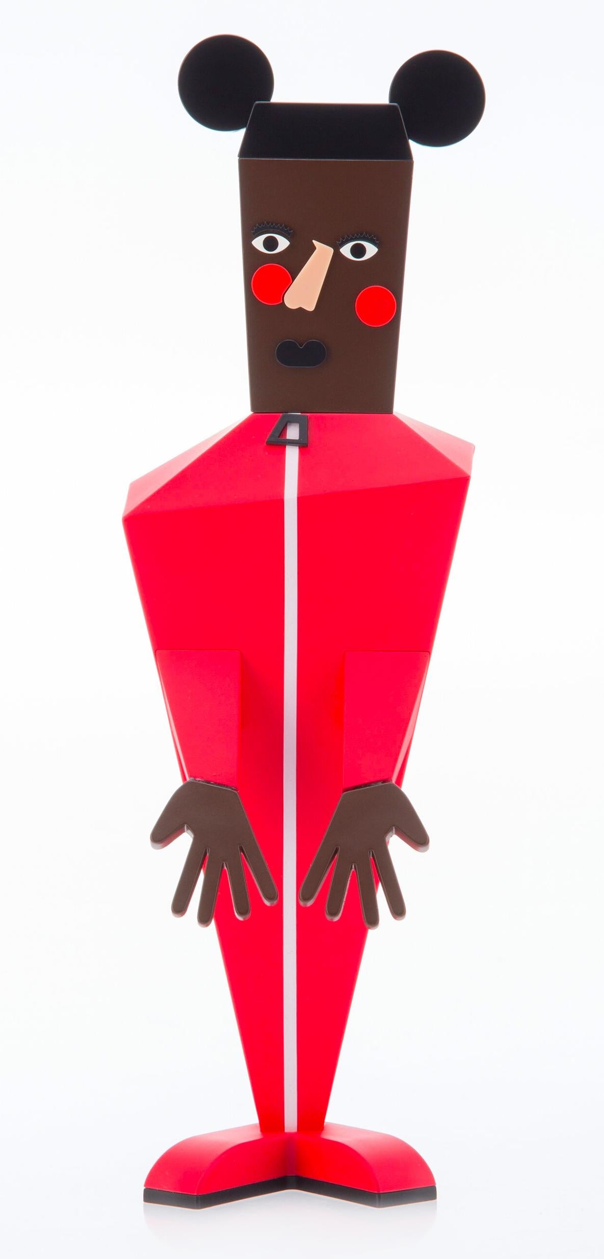 Nina Chanel Abney Baby: 
Nina Chanel’s 'Baby' figure strikingly re-imagines Mickey Mouse as a man dressed in a bright red jumpsuit, with mirroring red circles stamped on the cheeks. Constructed with sharp angles and an asymmetrical mold, the figure