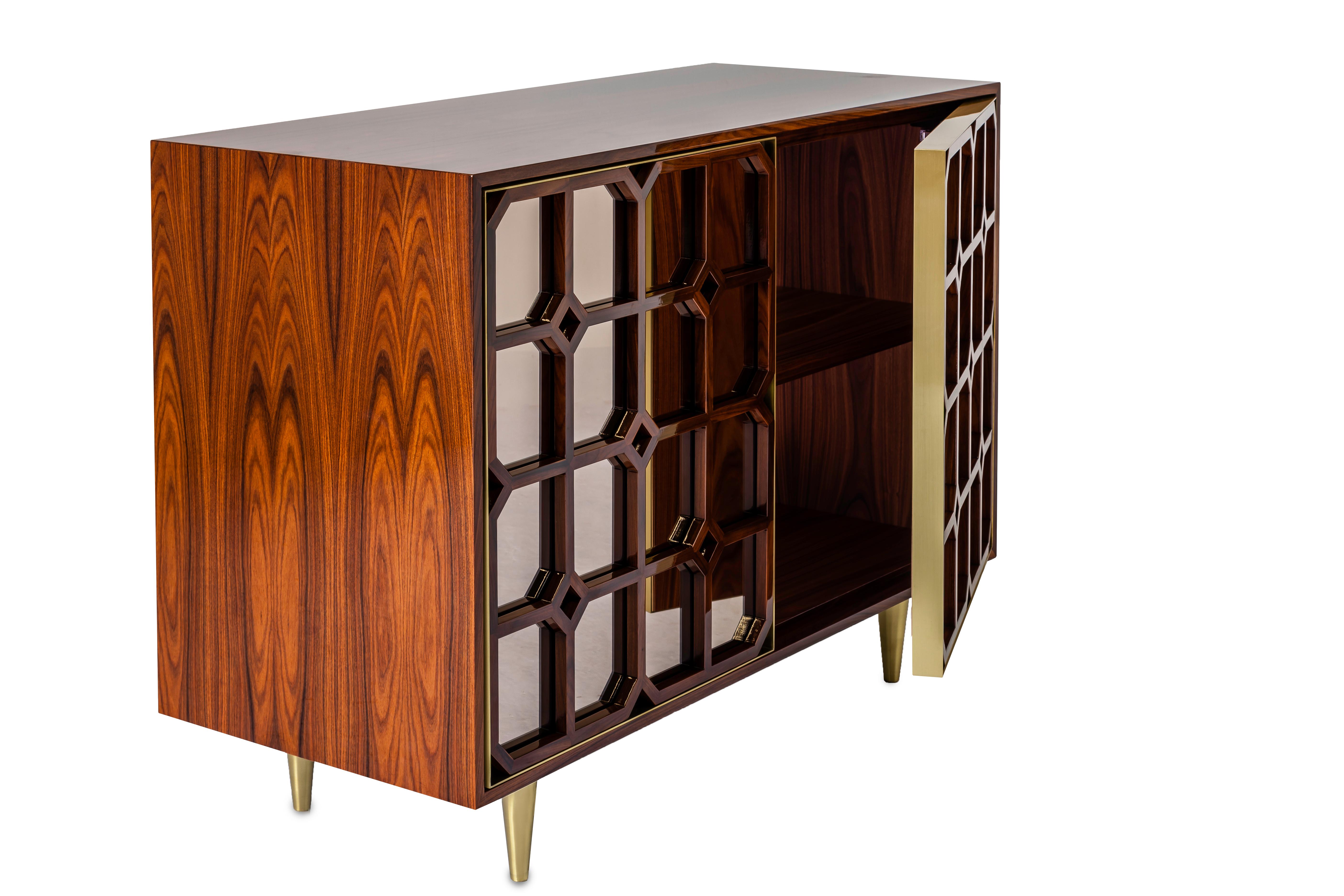 This credenza is inspired in Oriental antique screens and harmoniously combines natural wood, metal and bronze mirrors to create an impressive and sophisticated design, with its far inspirations and contemporary lines. The piece shows a strong