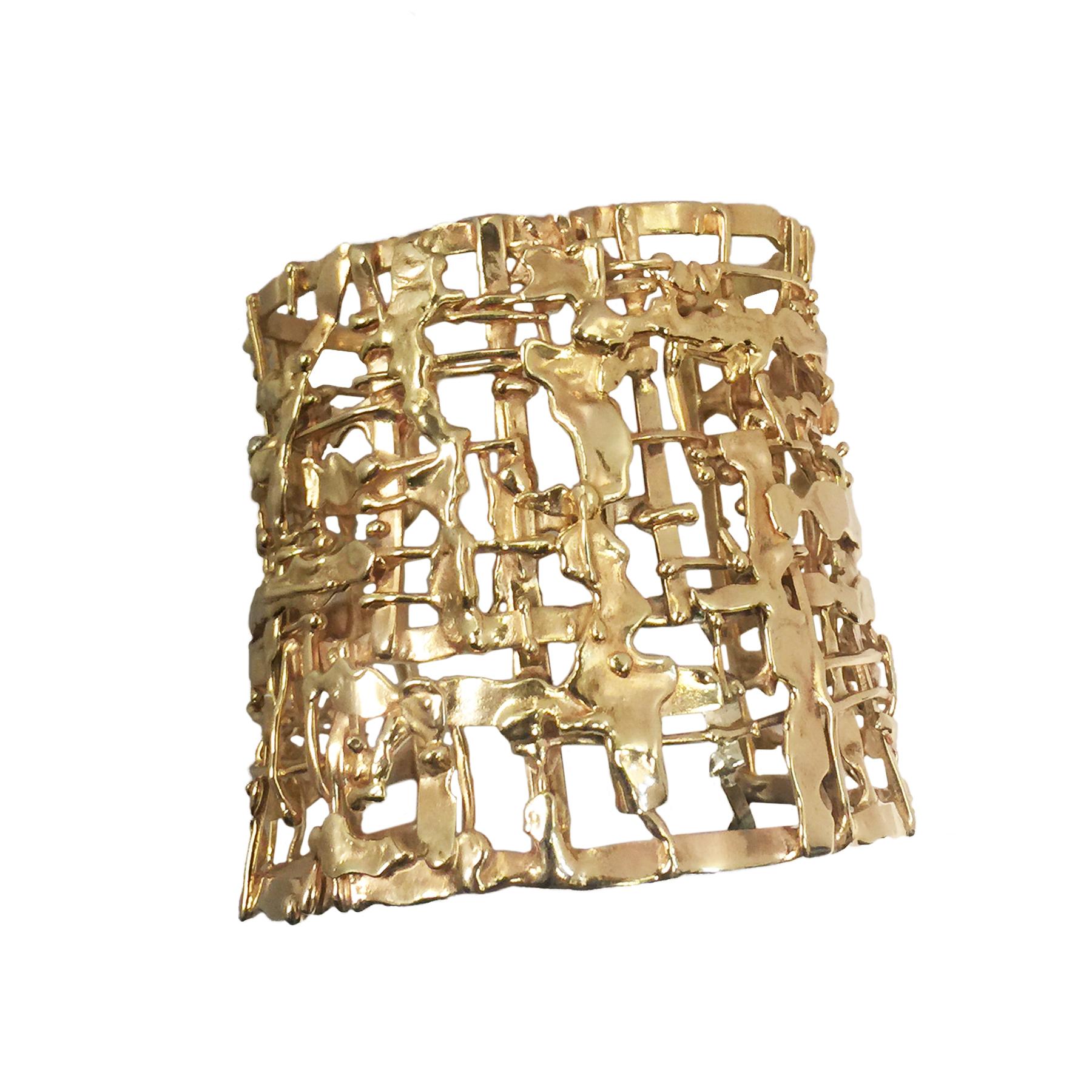 Circa 1960s Nina Lustig 14K Yellow Gold Mid Century modernist Cuff Bracelet, measuring 2 3/8 inches wide an opening of 1  3/8 inches an inside measurement of 7 inches and can be squeezed to be a bit smaller. All hand made with a slight tapering to
