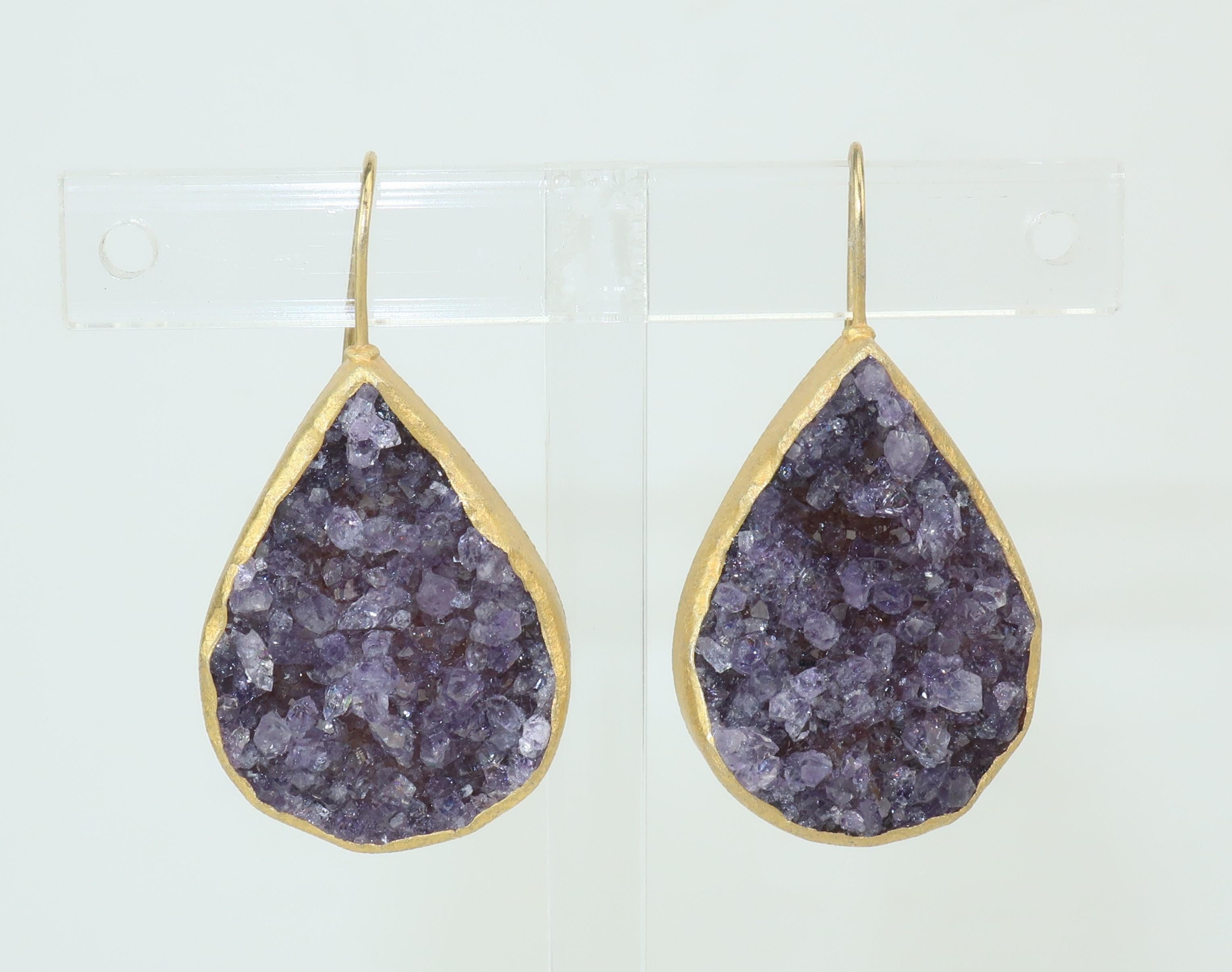 Beautiful gold vermeil sterling tear drop shaped amethyst geode earrings by Vietnamese/American designer Nina Nguyen.  The organic form of the design is the perfect backdrop for the brutalist look of the natural crystals.  Outfitted with fish hook
