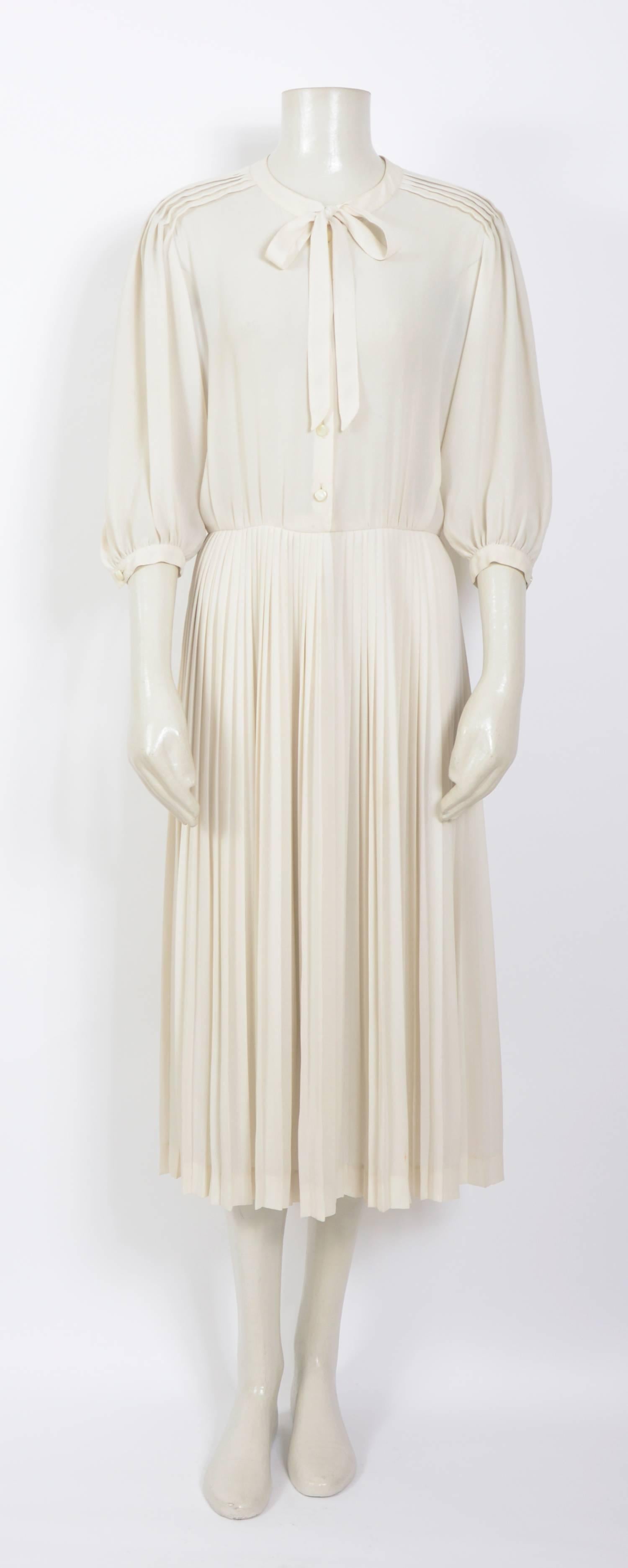 Beautifully made dress by Nina Ricci.
Unlined, pleated skirt, button front closure.
Measurements are taken flat: Ua to Ua 19inch/48cm(x2) - Waist 14inch/36cm(x2) - Total Length 46inch/117cm
