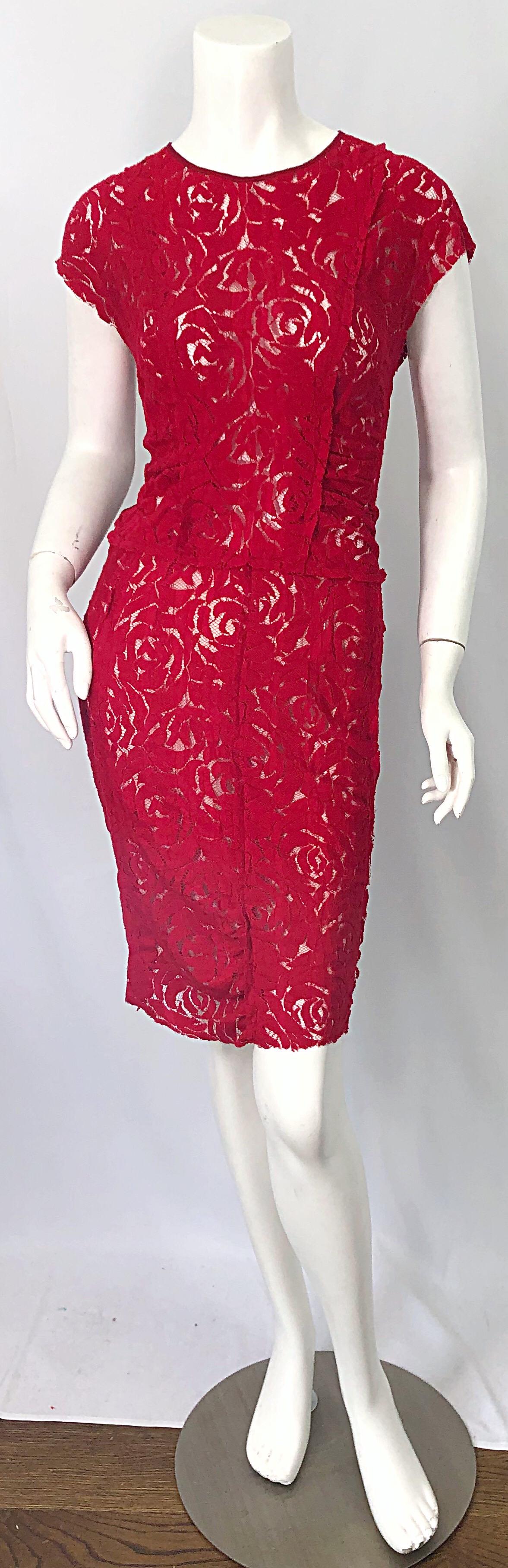 Beautiful early 2000s vintage NINA RICCI lipstick red lace dress! Features a semi sheer tailored bodice that stretches to fit. Short sleeves are perfect for any time of year. Knit panels at each side on the back. Hidden zipper up the back with