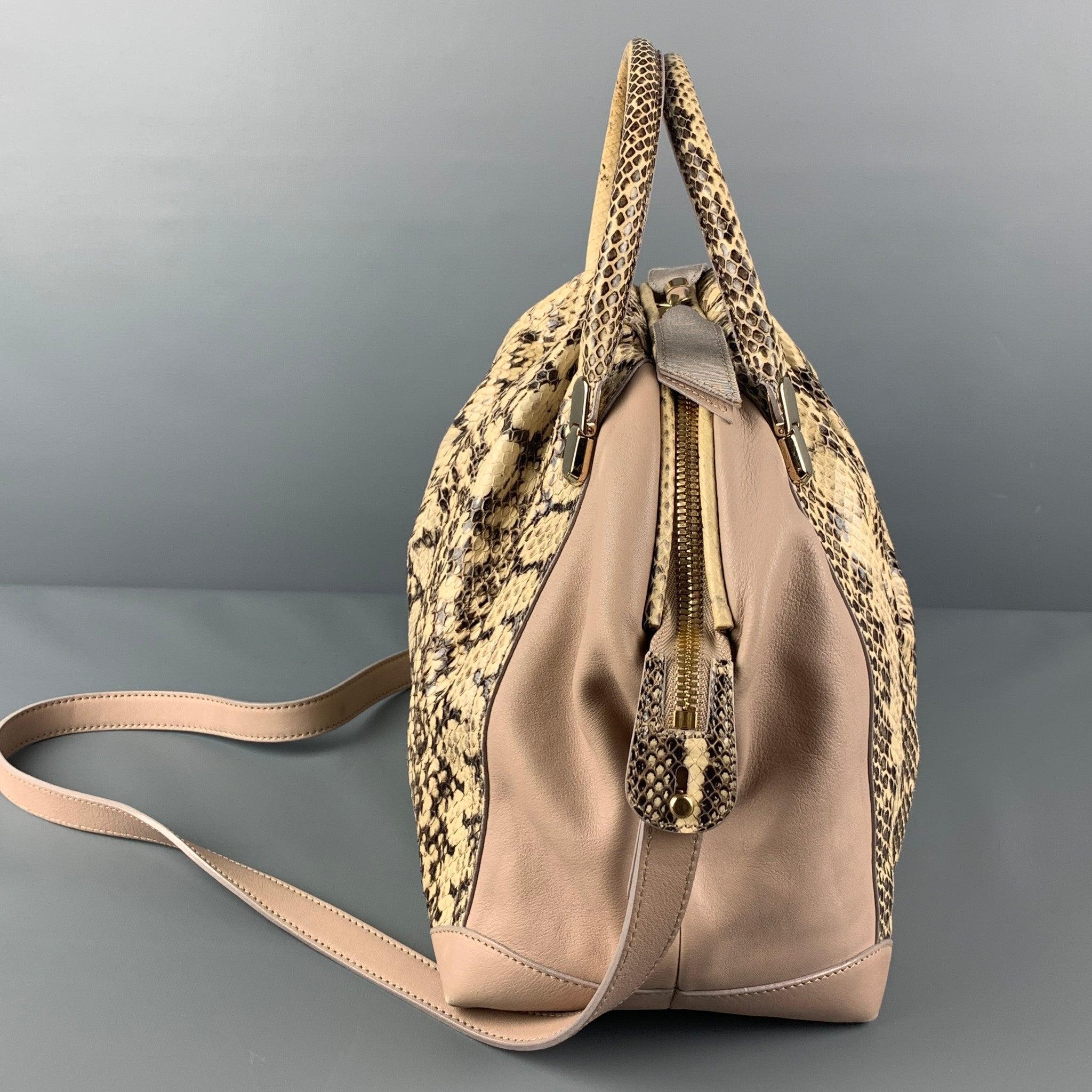 NINA RICCI bag comes in a beige & brown mixed leathers featuring top handles, removable shoulder straps, gold tone hardware, inner pocket, and a zipper closure. Made in Italy.
Very Good
Pre-Owned Condition. 

Measurements: 
  Length:12 inches 