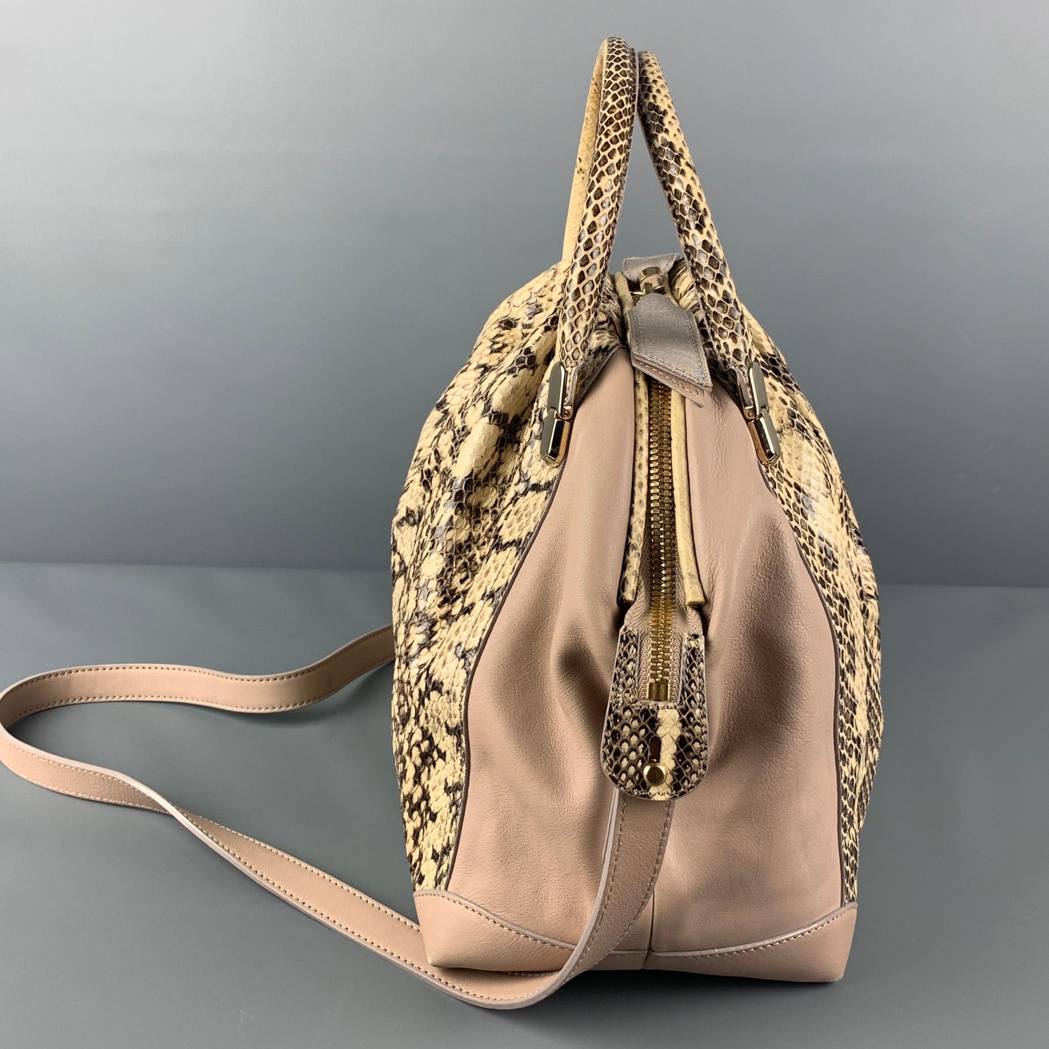 NINA RICCI bag comes in a beige & brown mixed leathers featuring top handles, removable shoulder straps, gold tone hardware, inner pocket, and a zipper closure. Made in Italy. 

Very Good Pre-Owned Condition.
Original Retail Price: