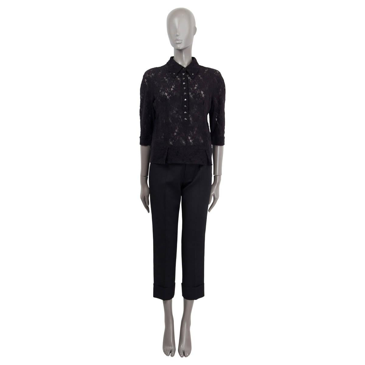 100% authentic Nina Ricci semi-sheer lace button-down blouse in black cotton and elastane (assumed cause tag is missing). Features 3/4 sleeves and buttoned cuffs. Opens with buttons on the front. Unlined. Has been worn and is in excellent