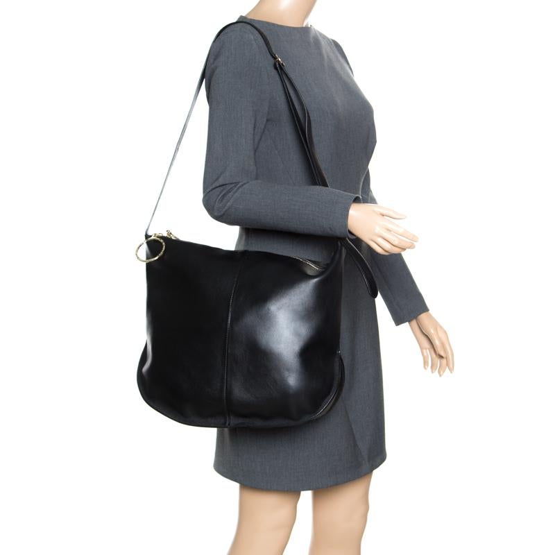 Nina Ricci brings you this Kuti hobo that will perfectly complement all your outfits. Crafted from black leather it has a suede lined inetrior secured by a zip top closure. The hobo features an adjustable shoulder strap and a zip pouch.

Includes: