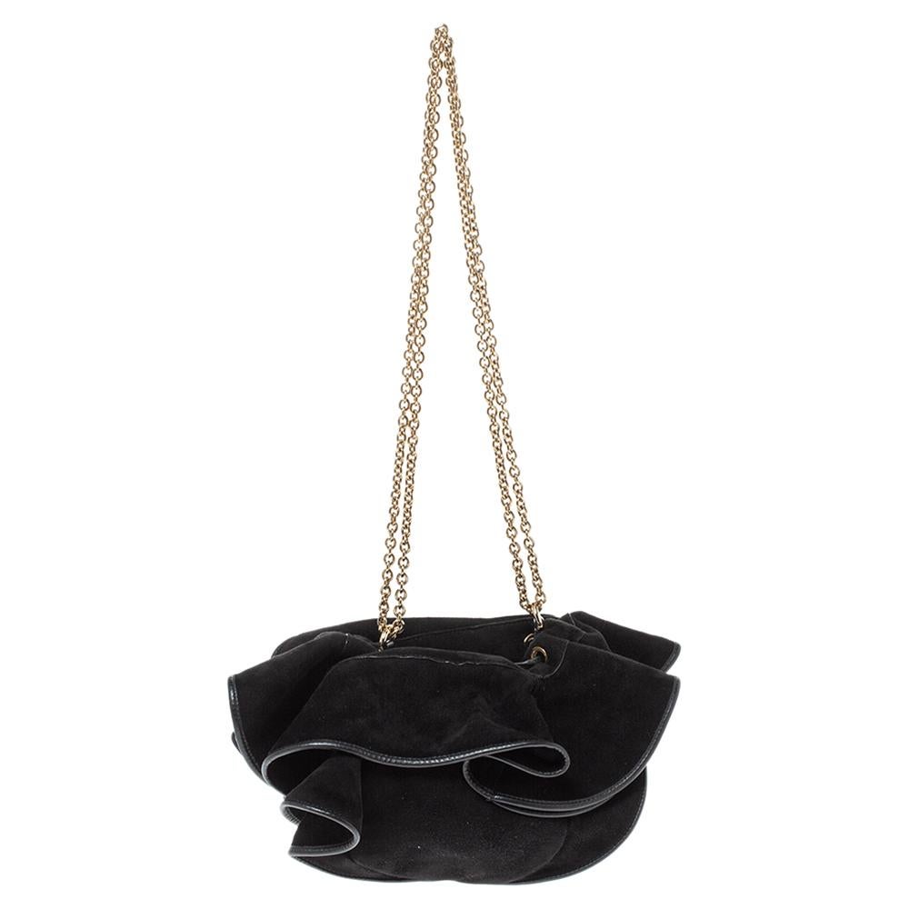 Gorgeous and elegant, this bag from Nina Ricci is totally worth the splurge. The black bag is crafted from suede and features a ruffled design. It flaunts shoulder chains and a drawstring that opens to a leather-lined interior capable of storing all