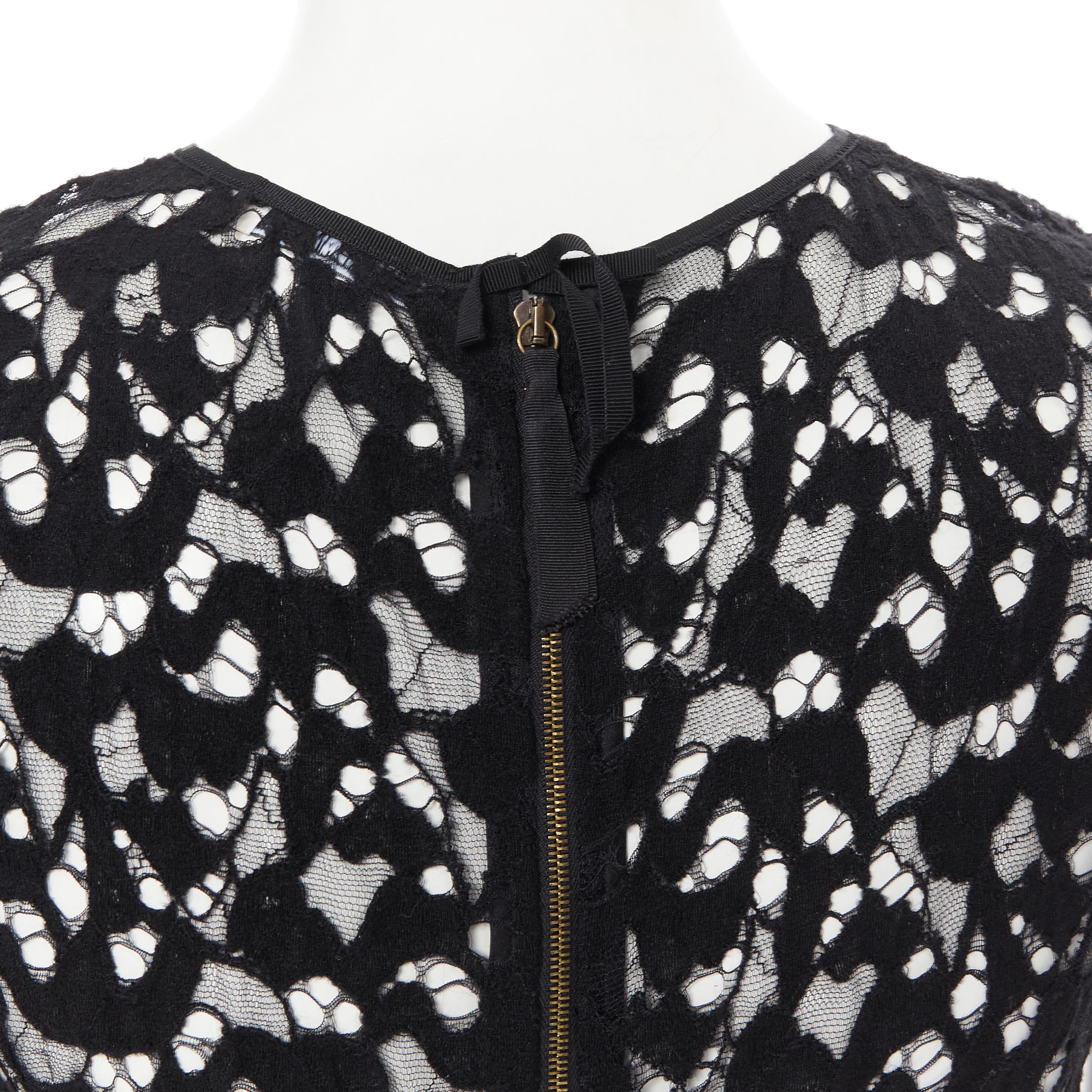 NINA RICCI black sheer lace cap sleeve zip back T-shirt top FR40 XS 
Reference: LNKO/A01830 
Brand: Nina Ricci 
Color: Black 
Pattern: Solid 
Closure: Zip 
Extra Detail: Zip back closure. 
Made in: France 

CONDITION: 
Condition: Excellent, this