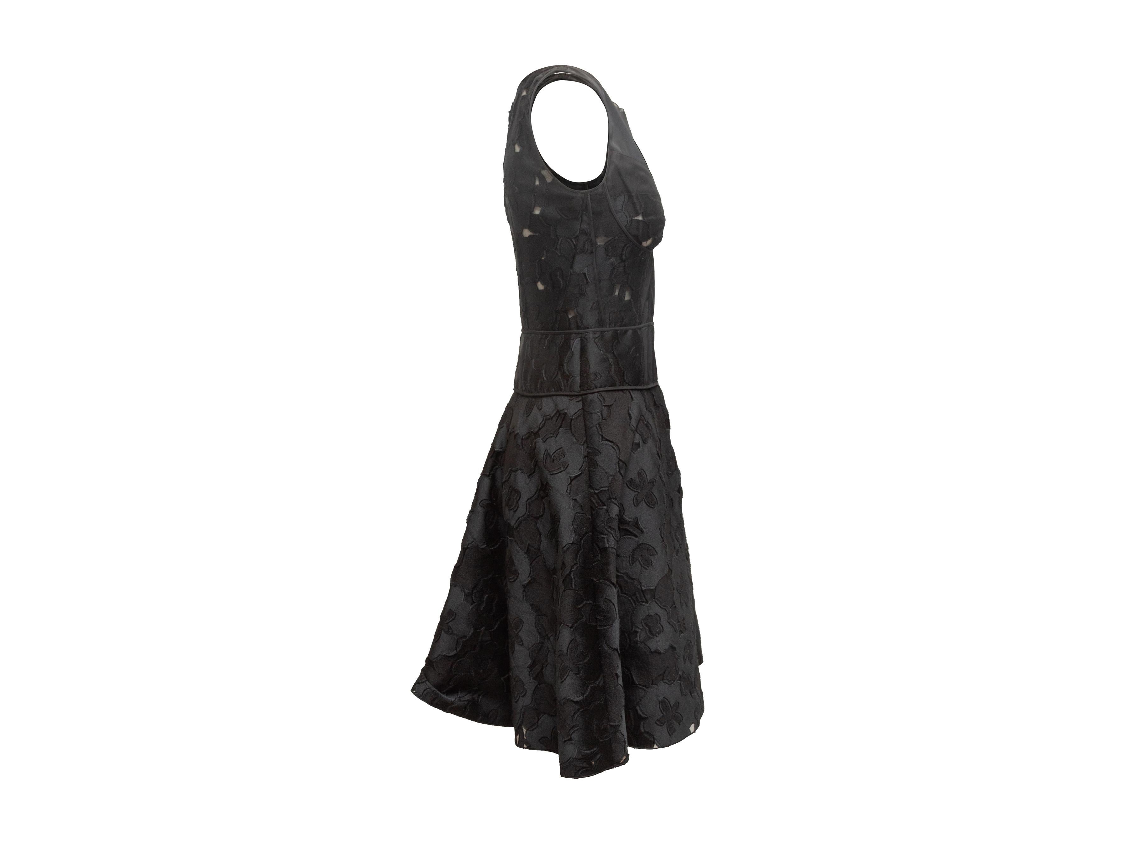 Product details: Black sleeveless floral patterned dress by Nina Ricci. Sheer panel detailing at bodice. Zip closure at back. Designer size 38. 32