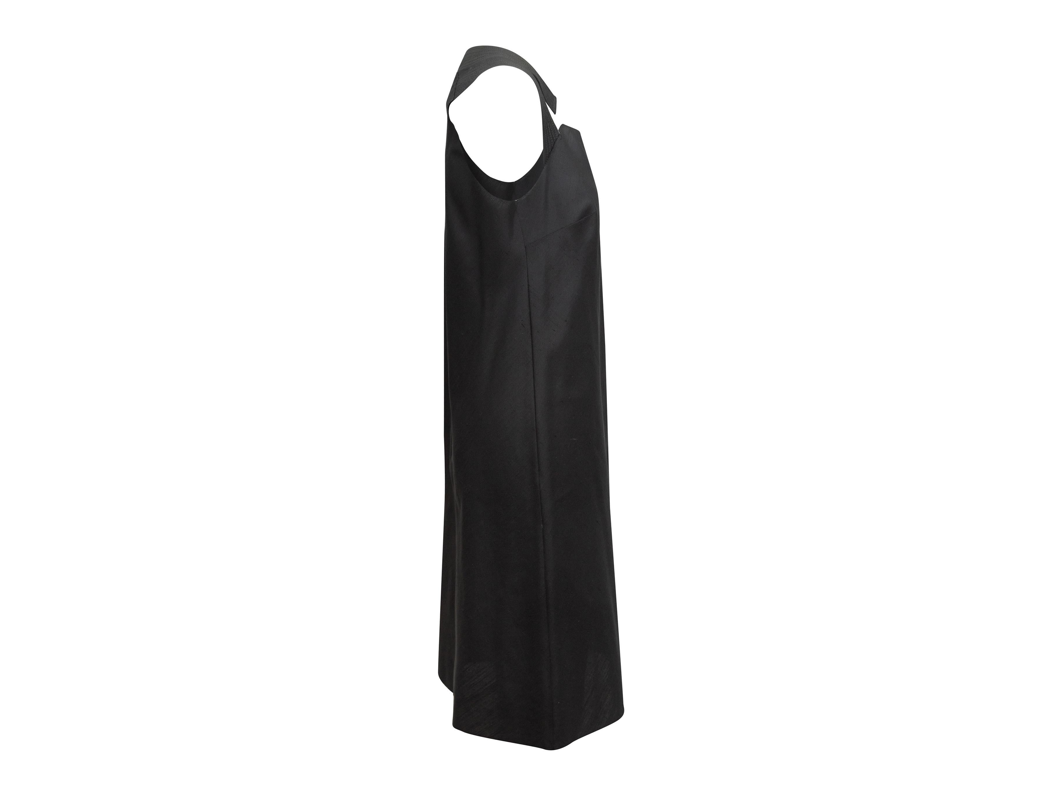Product details: Black sleeveless silk dress by Nina Ricci. Scoop neck. Cutouts at bust. 35