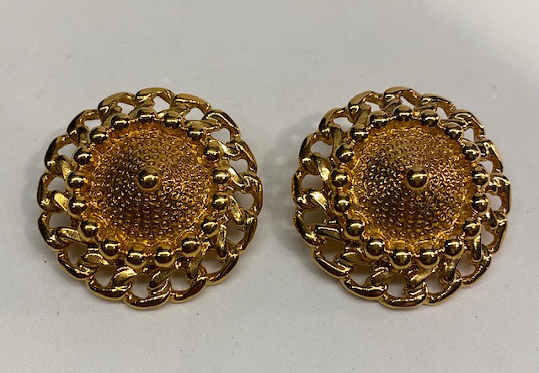 Excellent condition Nina Ricci 1980s gold tone domed button earrings with bead and curb chain boarder. Each earring is 1.38 inches in diameter and .63 of an inch high including the clip back. Bright and shiny gold plate. Back of clip stamped Nina