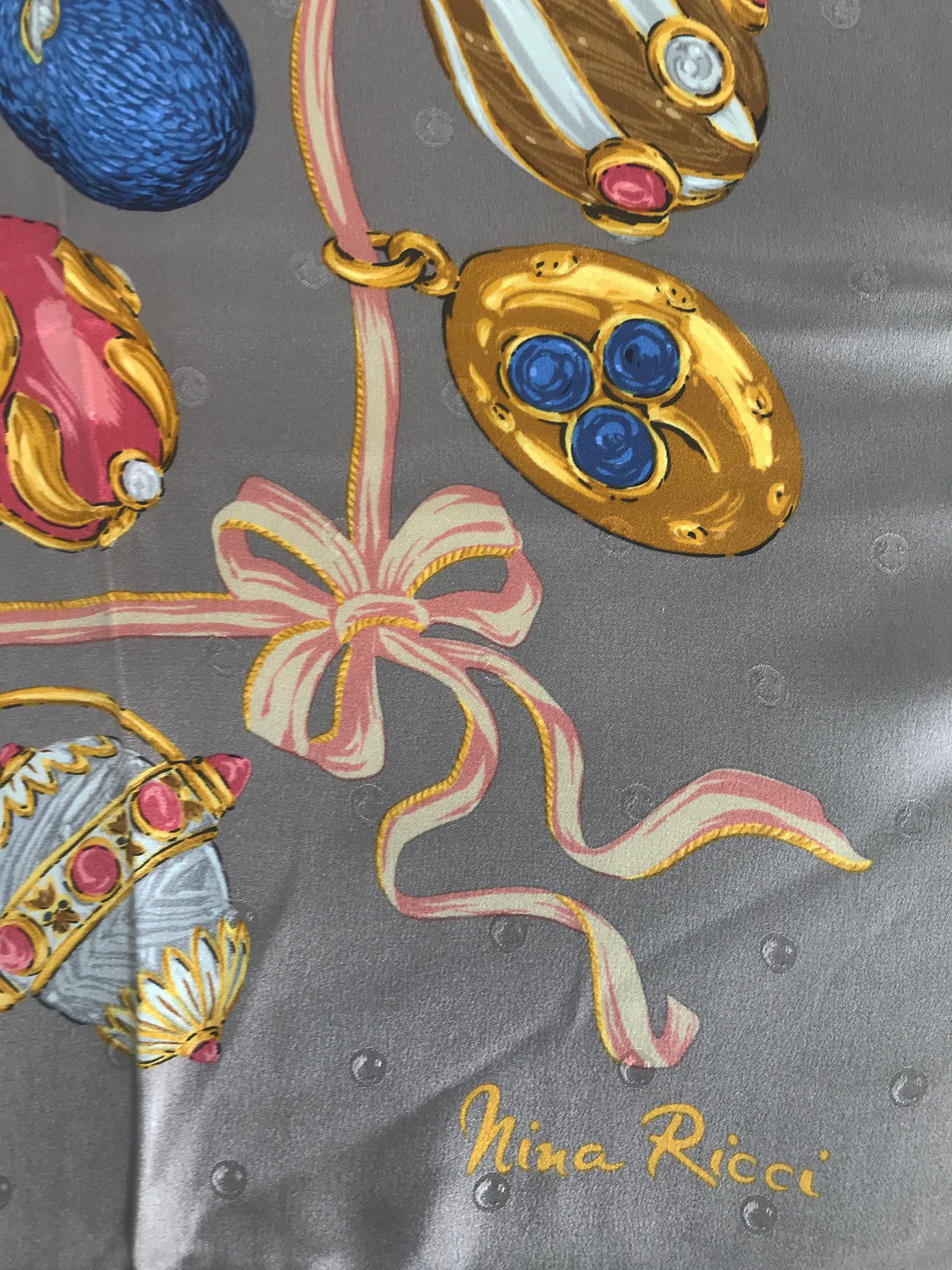 Nina Ricci charms silk satin jacquard scarf from the 1980s. Pale grey ground with woven dots that look like bubbles, only seen in the light. The print is Faberge like enamel egg charms with decorative ribbons. A very beautiful scarf in excellent