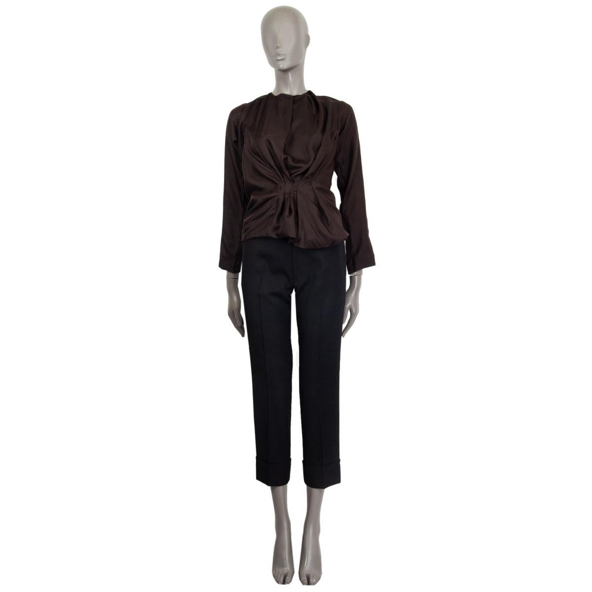 100% authentic Nina Ricci long sleeve gathered blouse in espresso brown silk (100%) with elastic gathered band on the bottom. Opens with a button in the neck. Has been worn and is in excellent condition. 

Measurements
Tag Size	34
Size	XXS
Shoulder