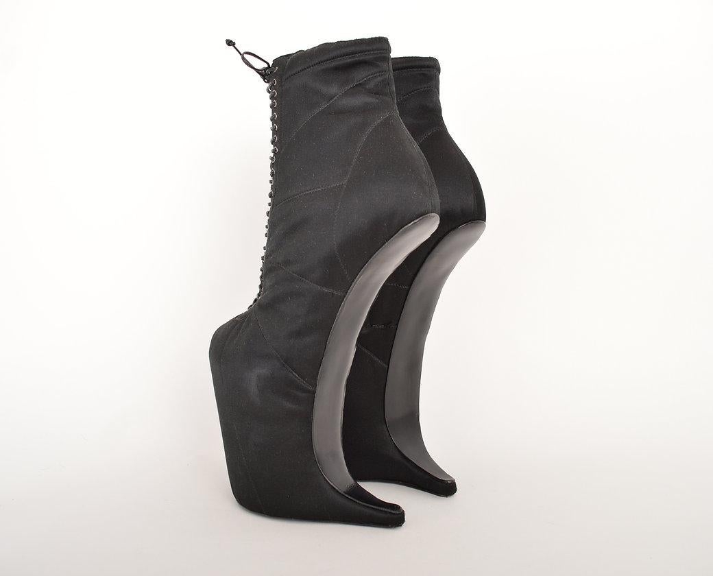 FALL/WINTER 2009 Runway boots by NINA RICCI. Black satin with fine lace up detail and incredible unusual construction featuring an avant-garde heel-less shape. 
 
Features;
Concealed side zip
Leather Lace up detail
Leather soles
MADE IN ITALY
